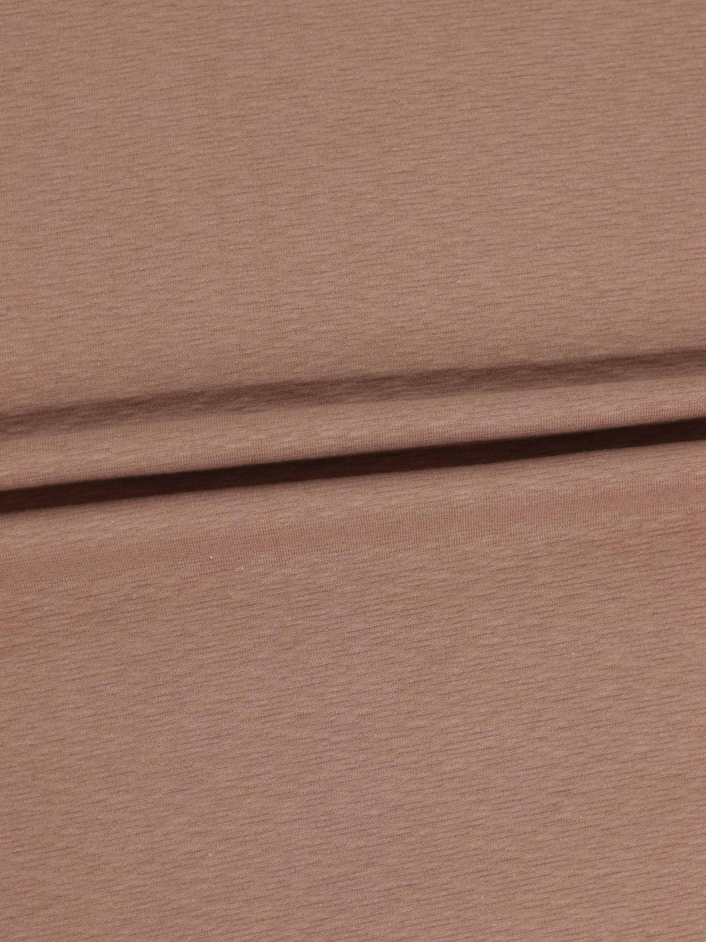 Dusty pink textured stretchy fabric close-up with a fold.