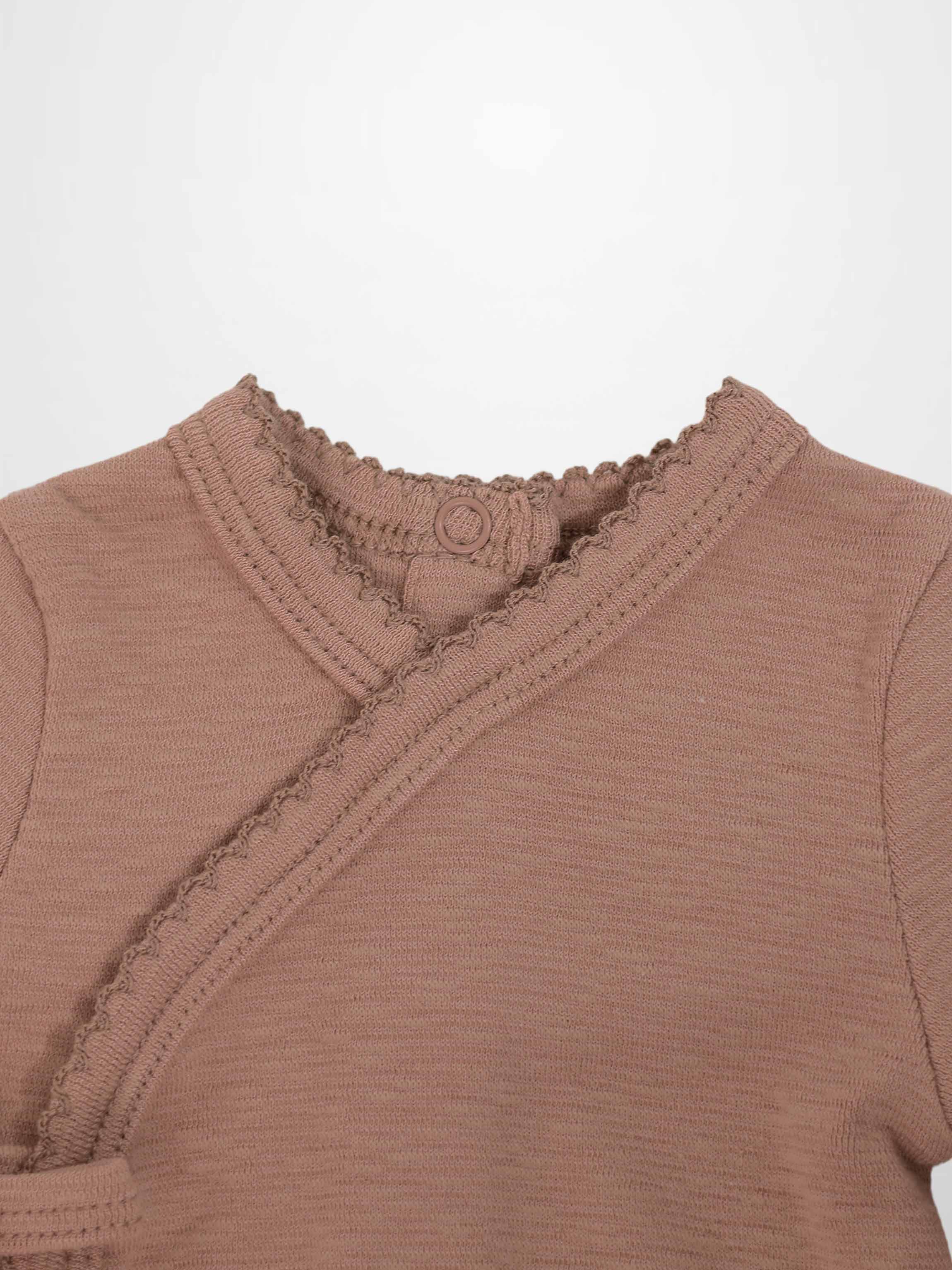 Pink Scalloped Stretchy baby jumpsuit top in dusty pink with a crossover wrap and scalloped trim.
