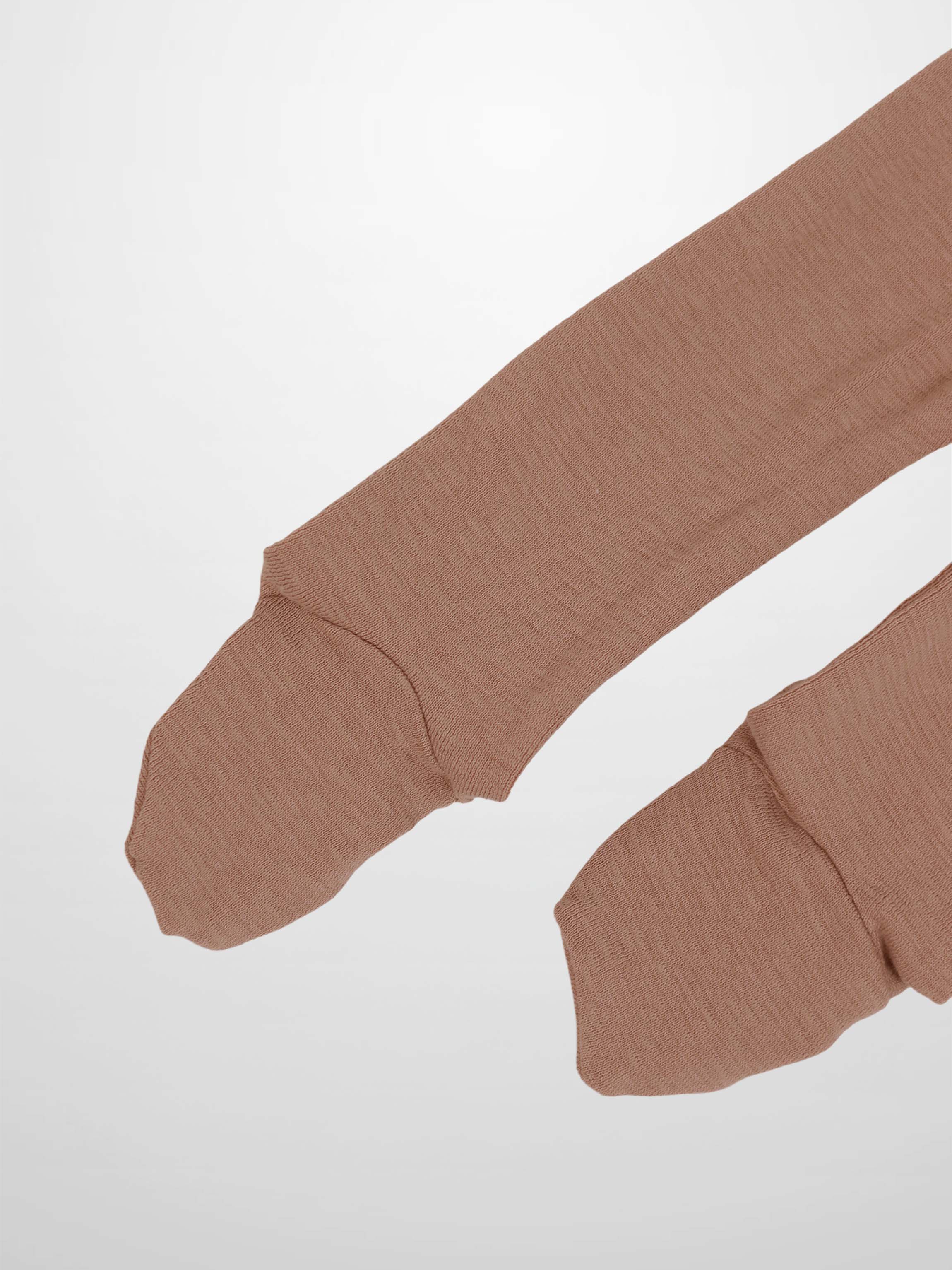 Dusty pink ribbed sleeves from a baby jumpsuit, soft breathable stretchy fabric.