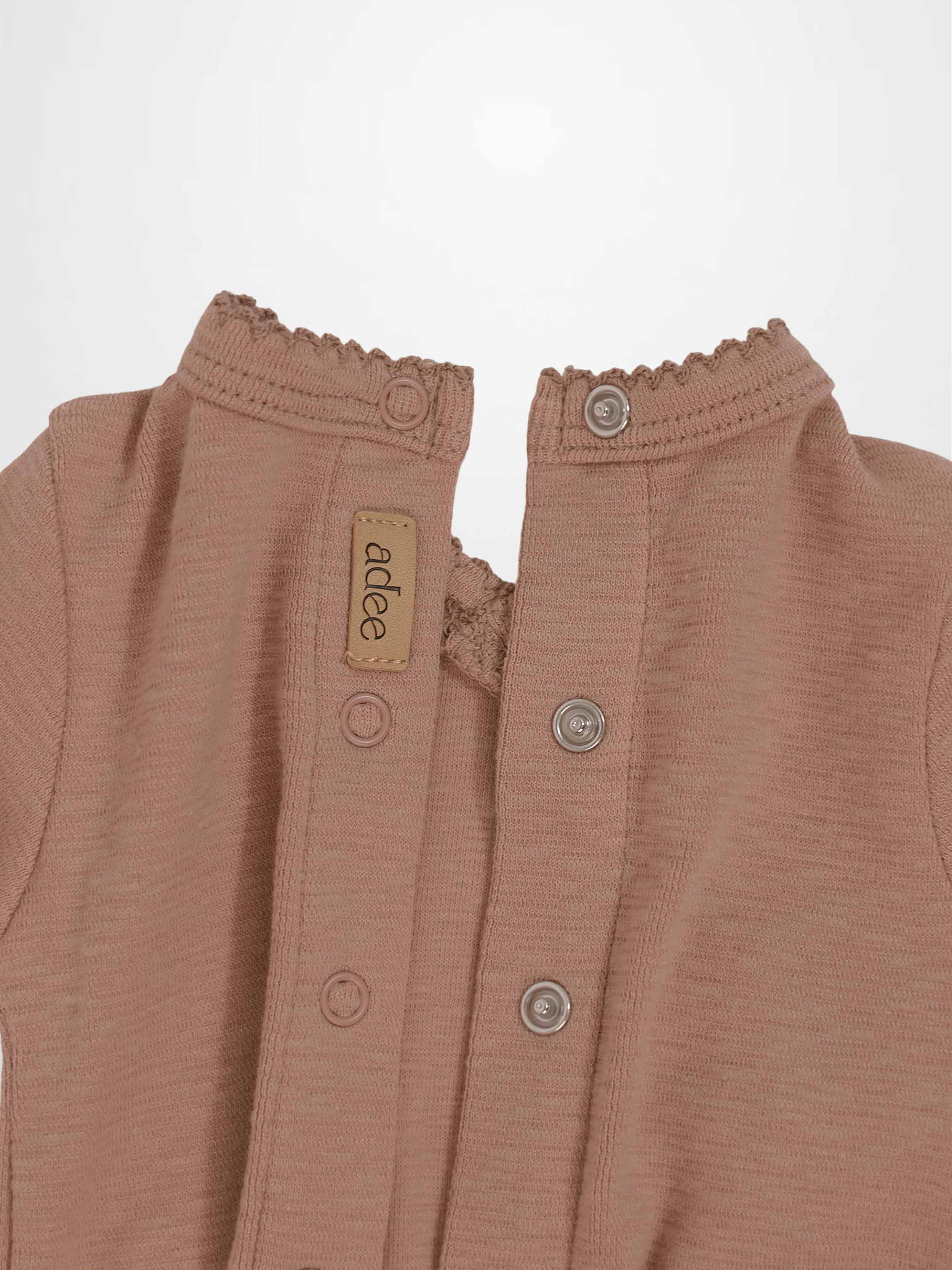 Dusty pink scalloped stretchy baby girl jumpsuit footie with textured fabric and side crossover detail