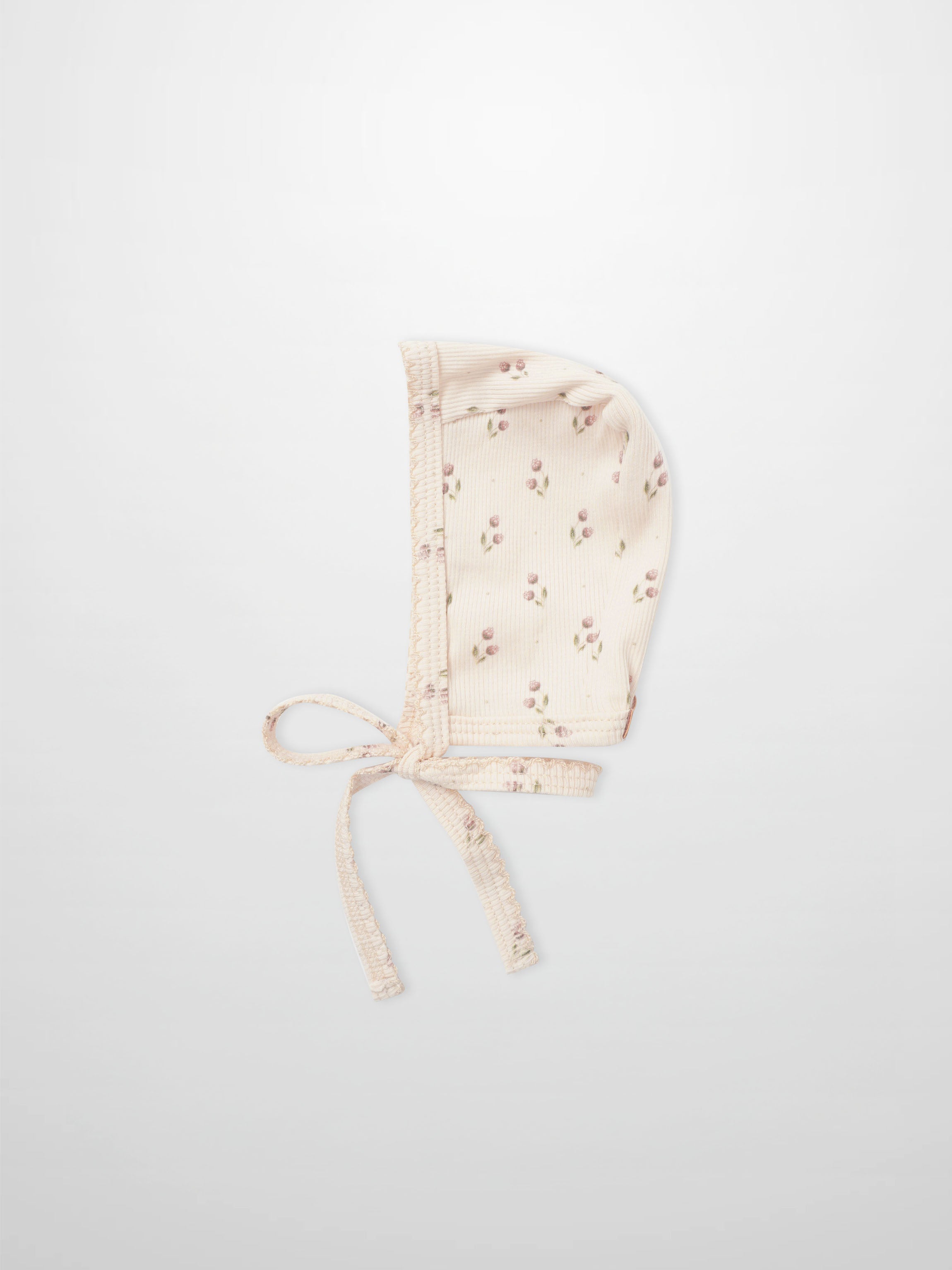 Tiny Tulip layette bonnet in pale pink with tiny floral print and ties