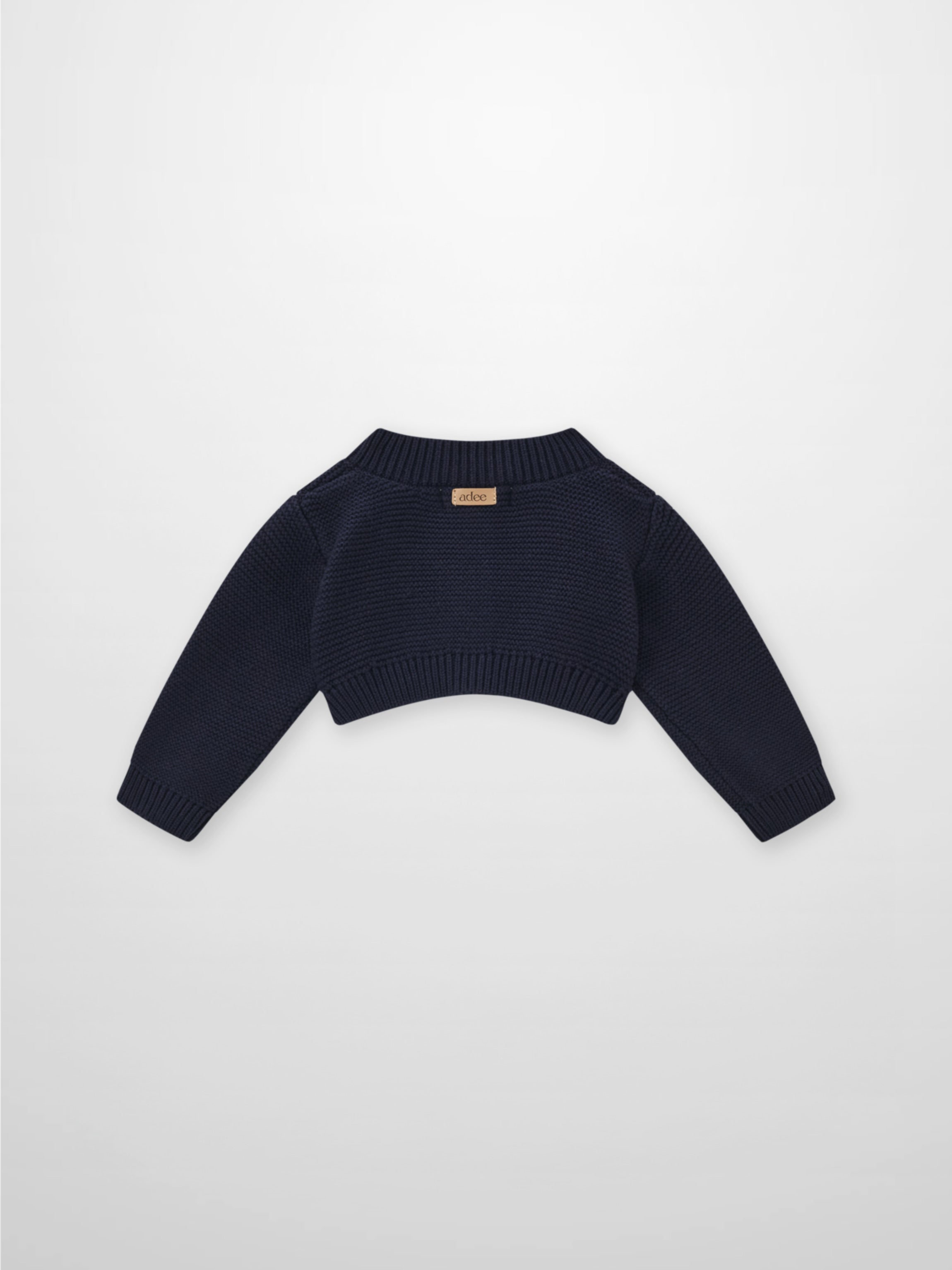 Cropped cardigan navy by Adee; unisex dressy knit with ribbed hem and cuffs.