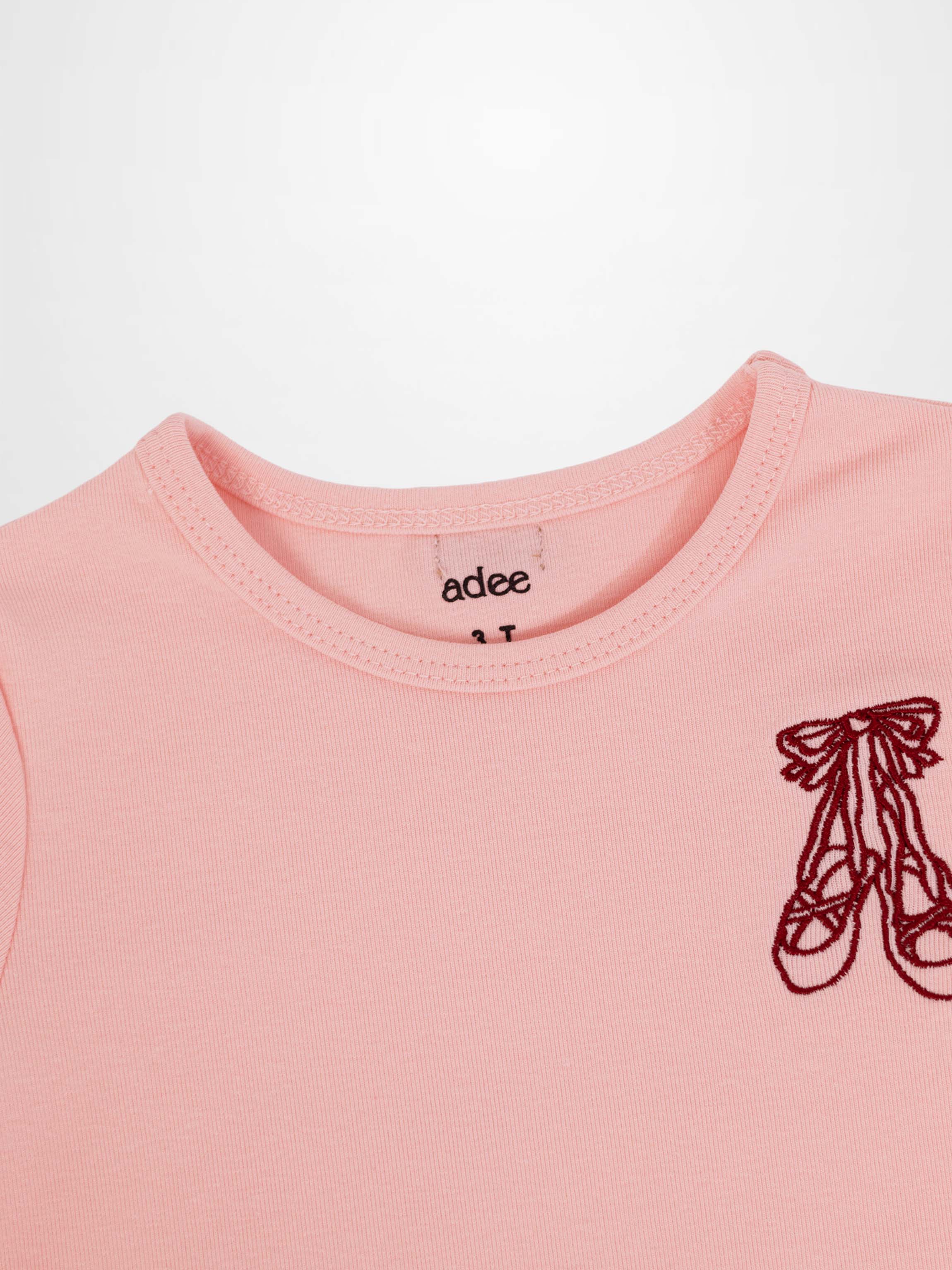 Light pink 3/4 sleeve T-shirt with burgundy ballet slippers embroidery on chest.
