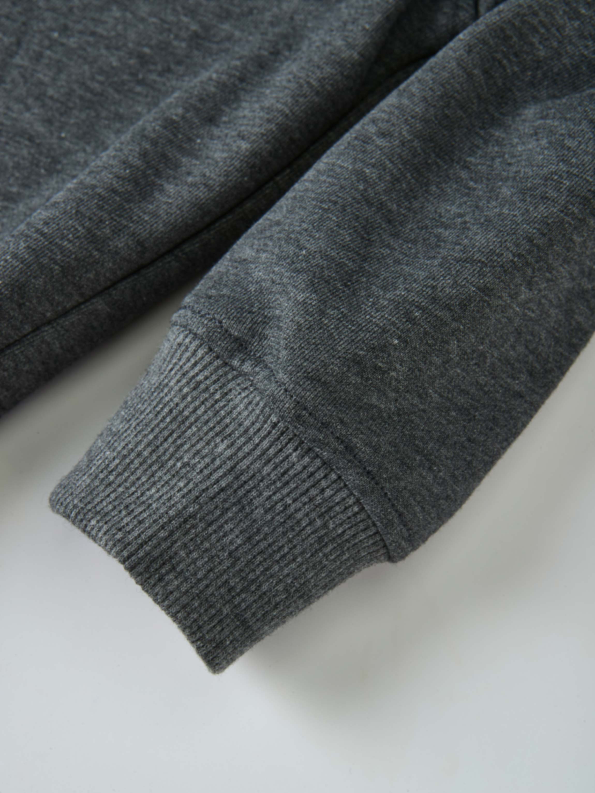 Windsor Sweatshirt by Adee; unisex top in gray heather knit with ribbed cuffs.