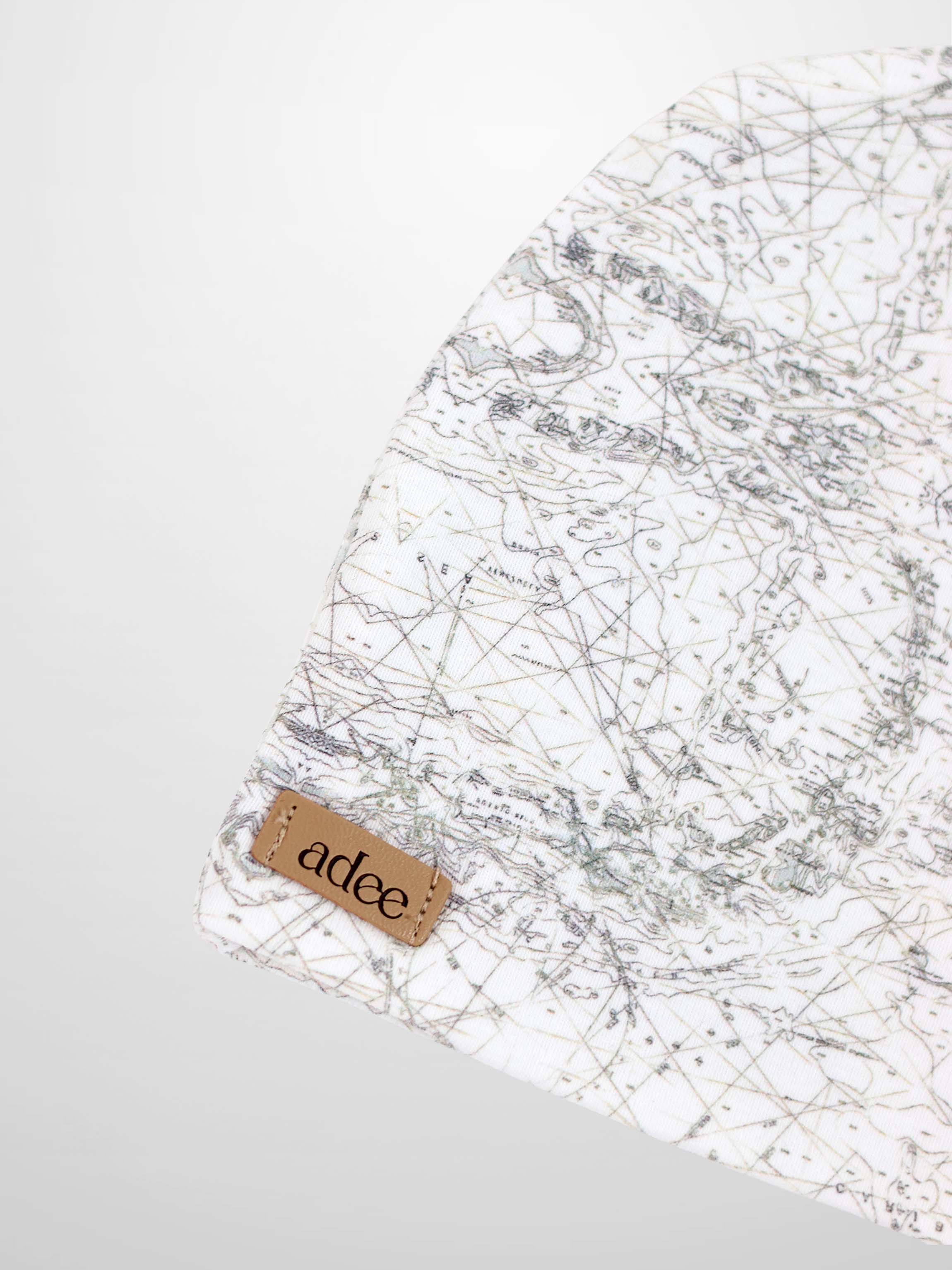 Off-white Map Beanie for babies with a map print, compass markers, grey lines, decorative stitching, and breathable.