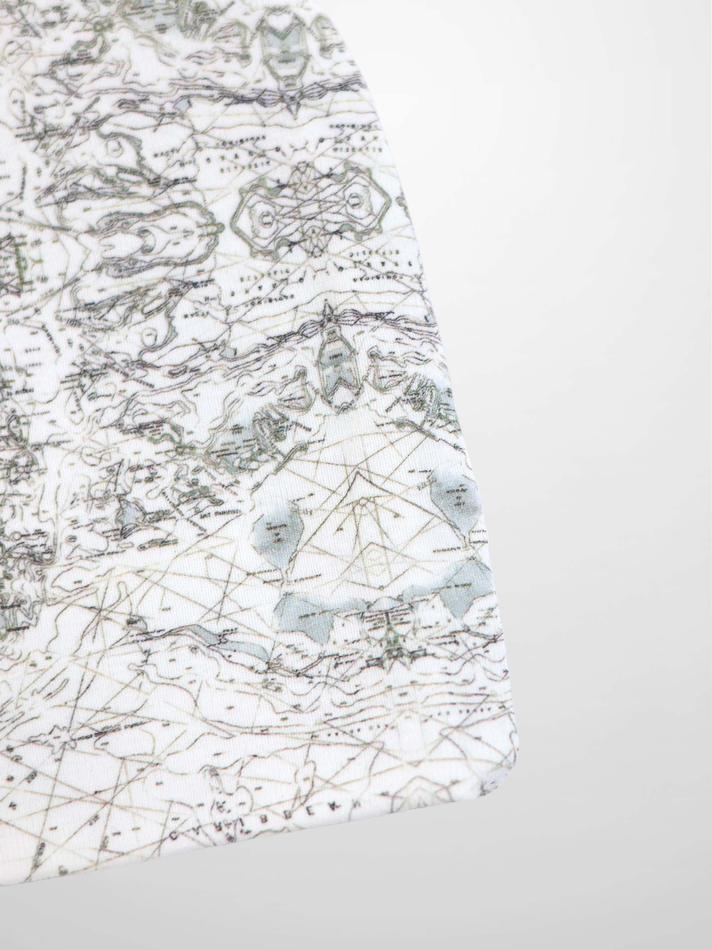 Map Beanie for baby boys, off-white with a fine map print, compass markers, and decorative stitching.