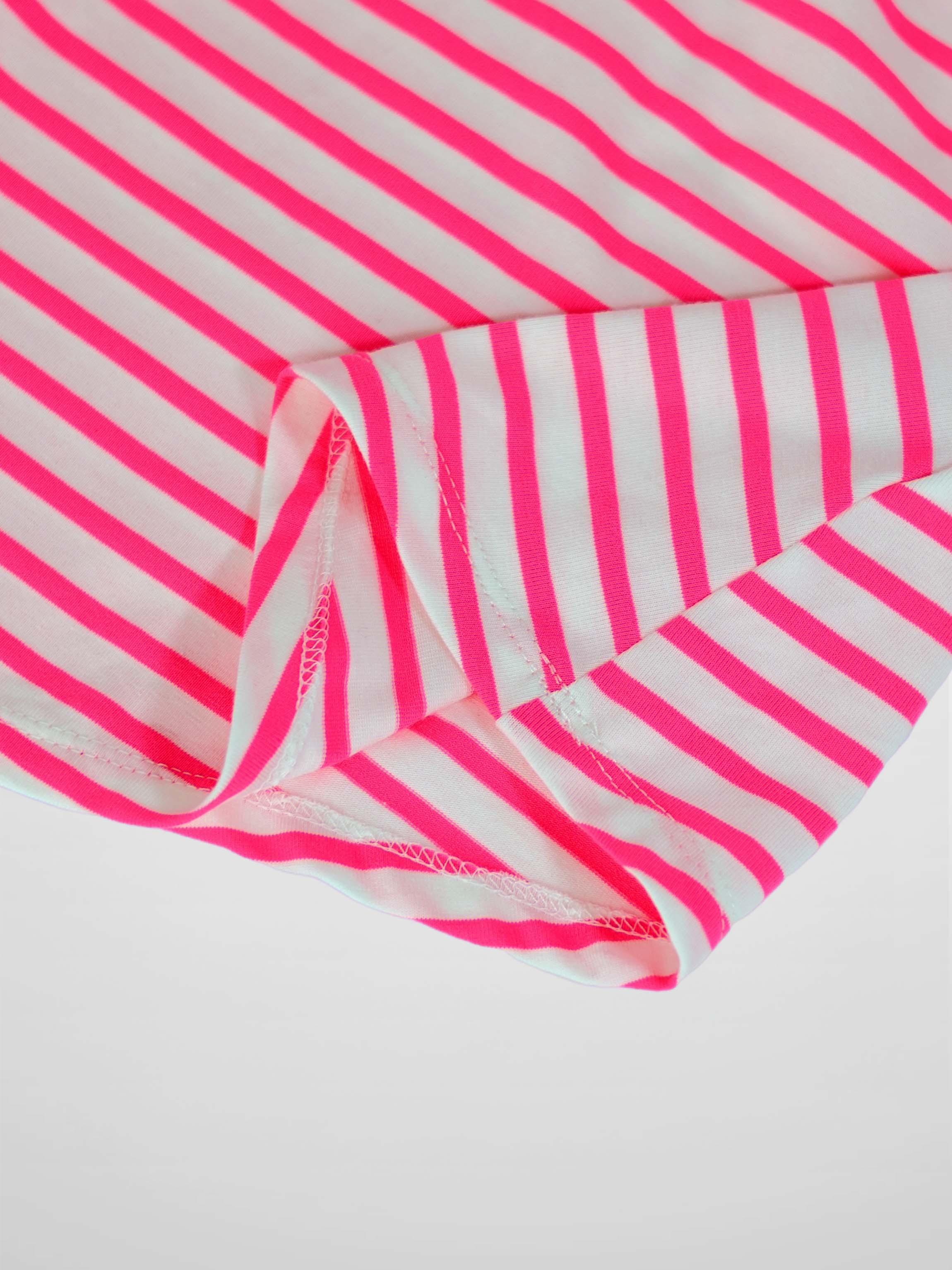 Neon pink and white striped fabric from a short-sleeve dress, with visible stitching along the hem.