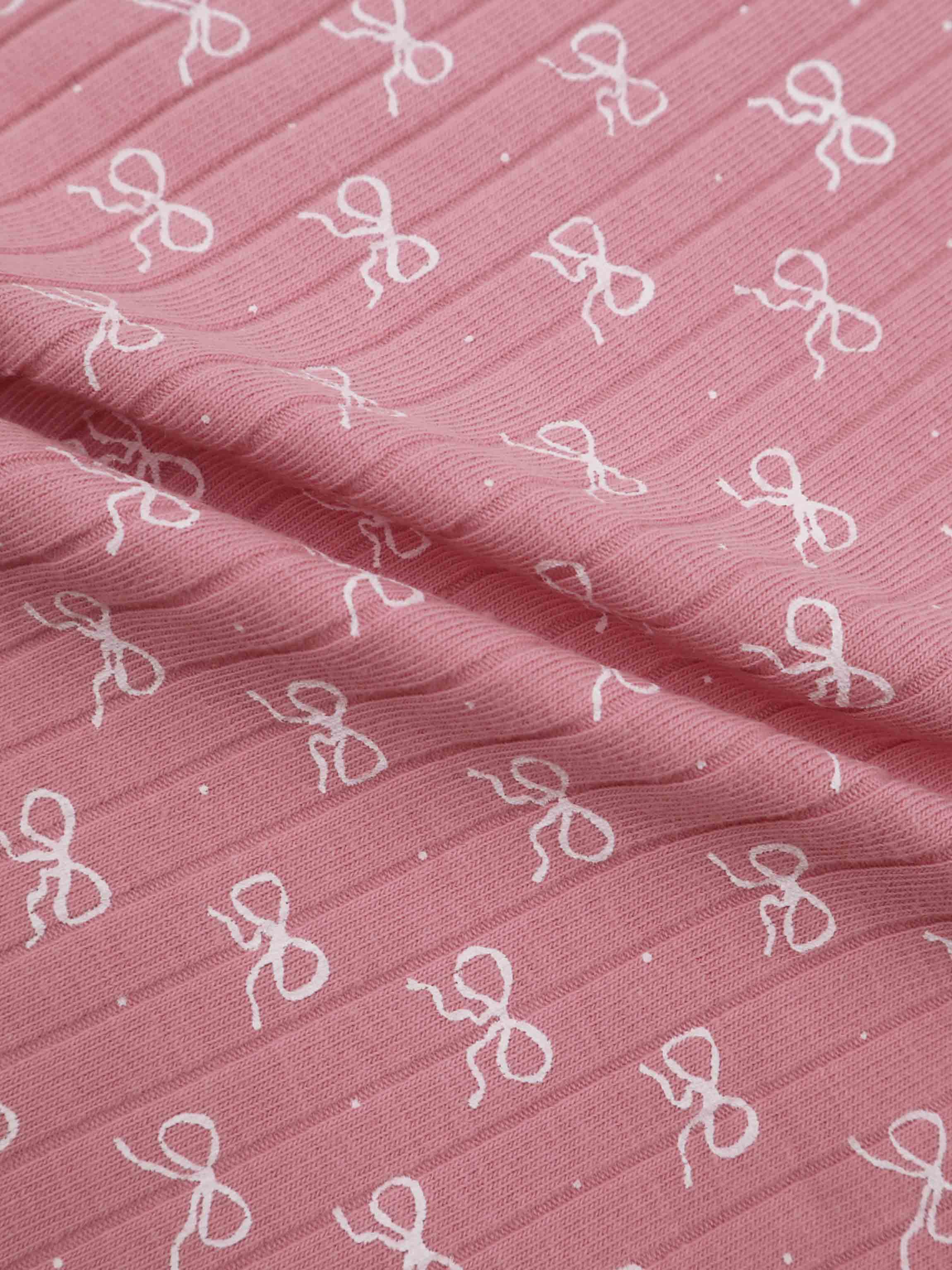 Bow print on pink fabric