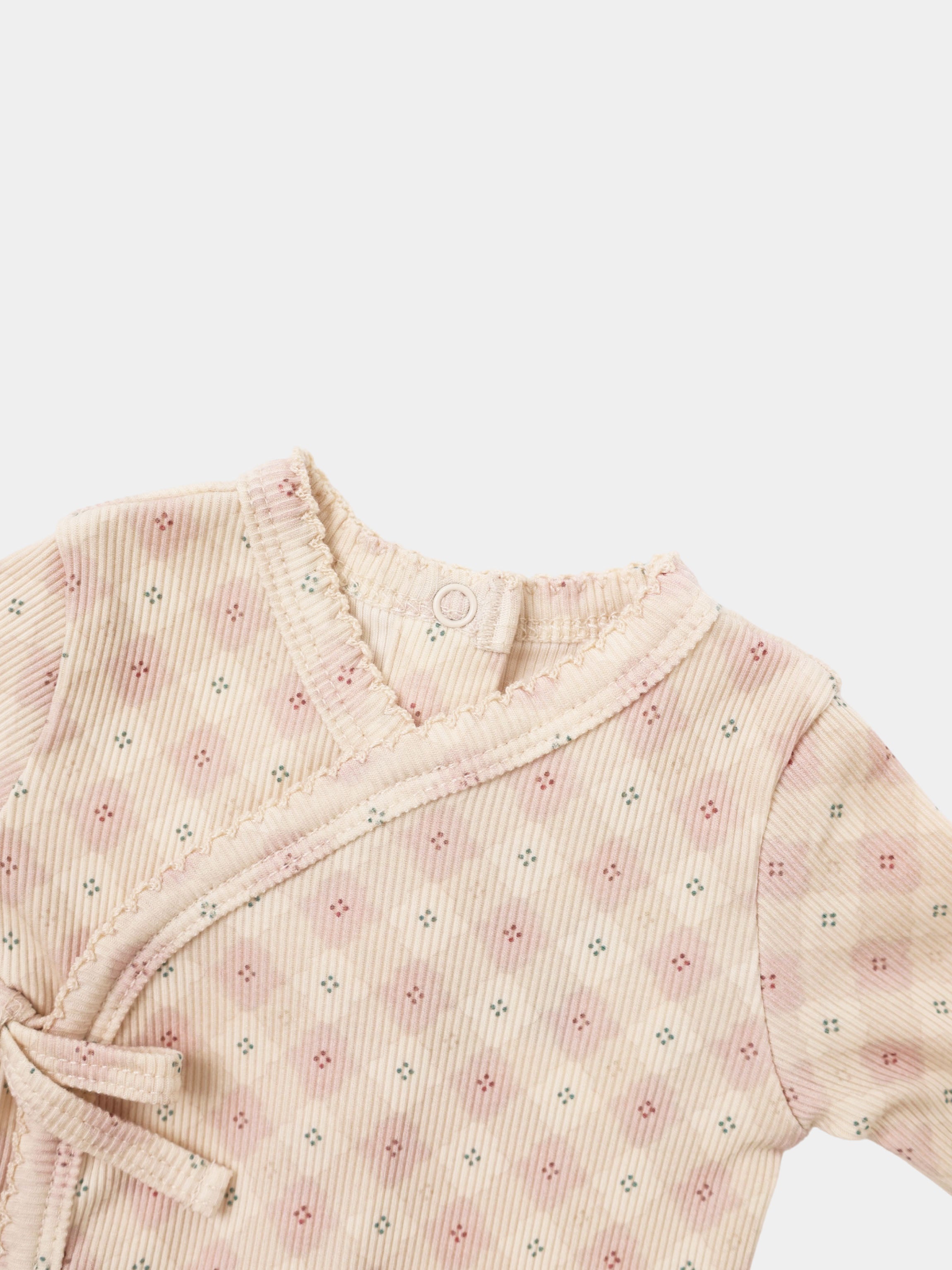 Little Button Pink layette set top for baby girls, pale pink ribbed fabric with tiny floral dots and ruffled neckline.