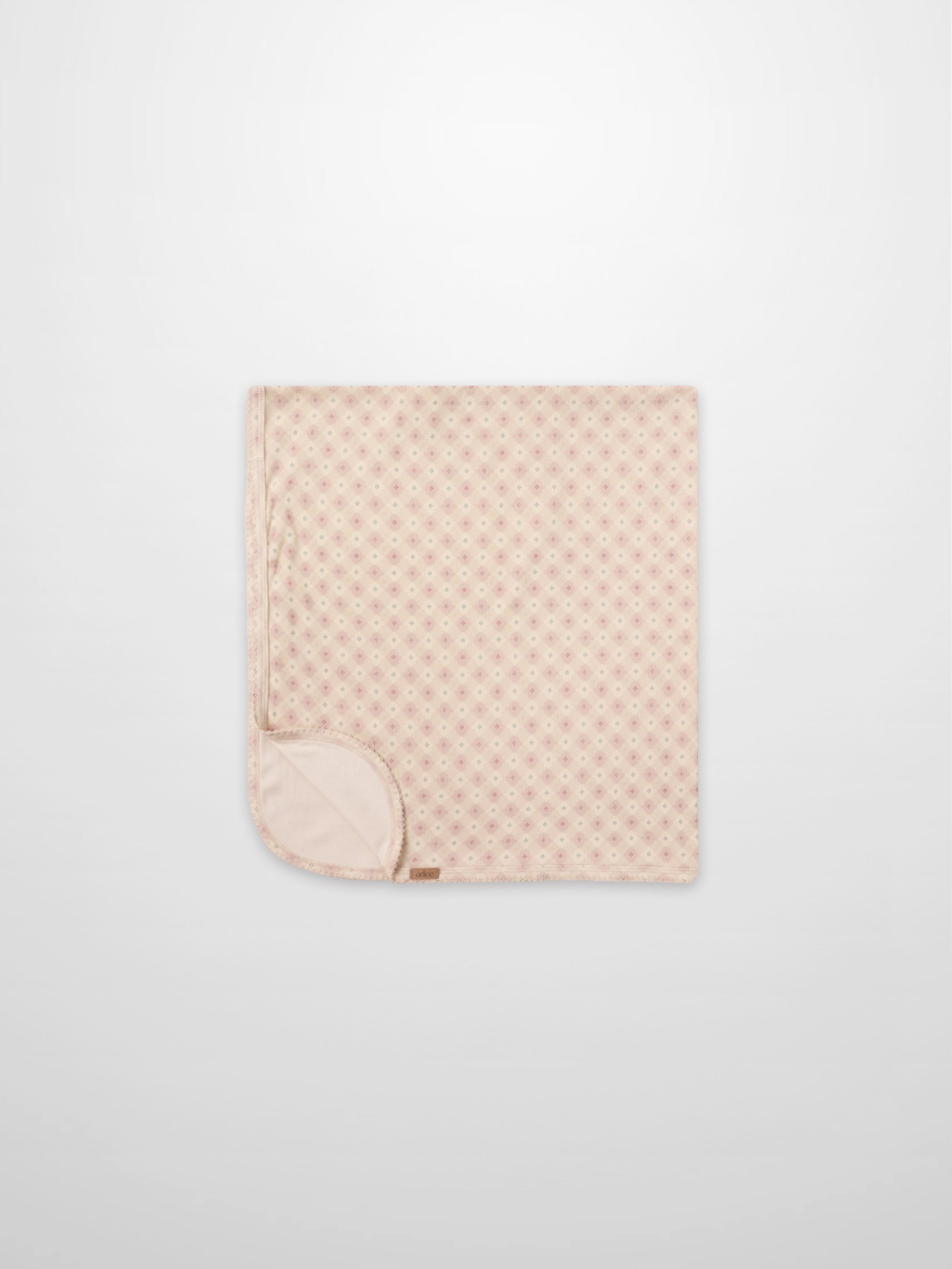 Little Button Pink layette set by Adee; pink baby blanket folded with tiny dot pattern