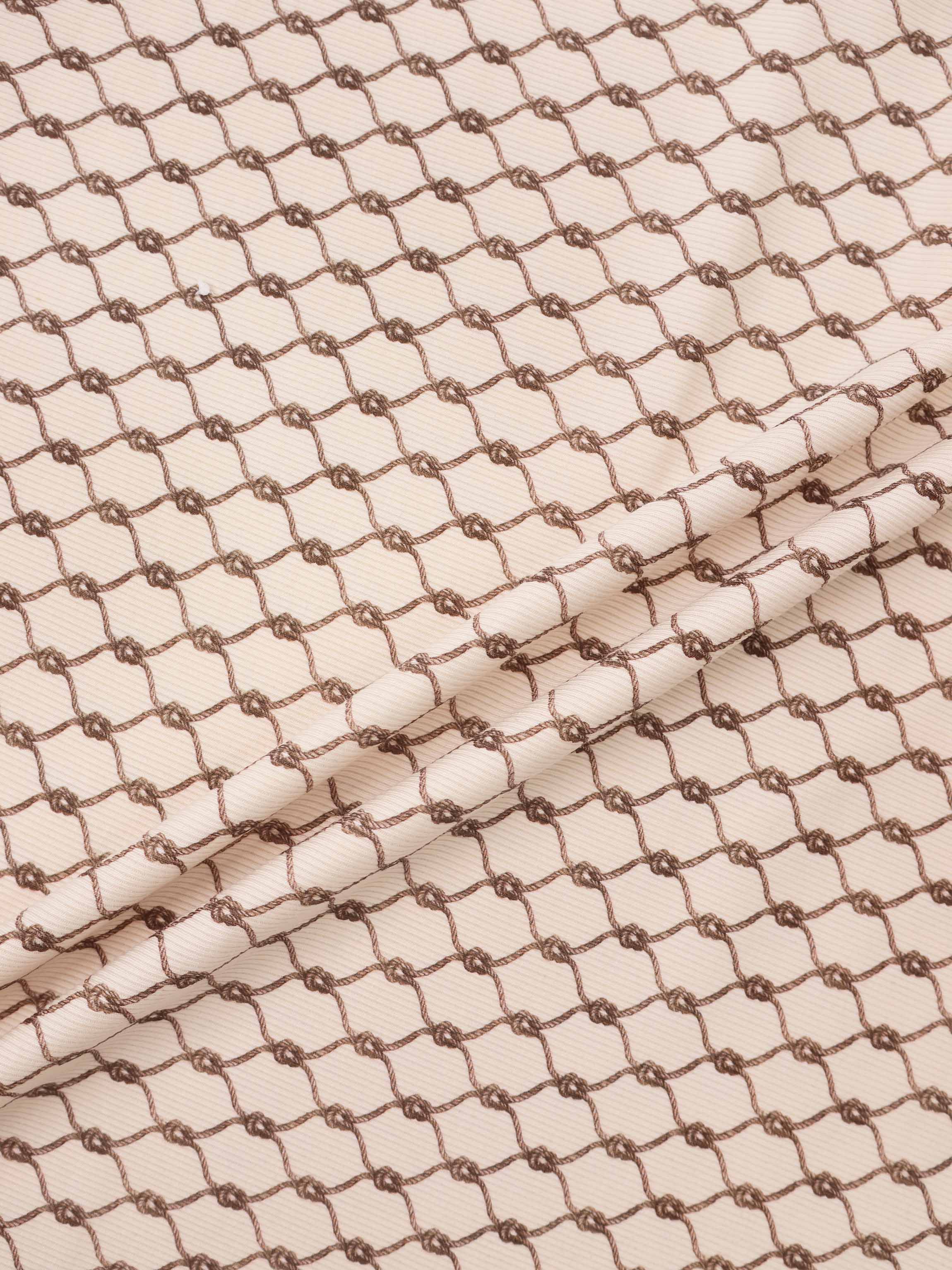 Brown Chain Layette Set fabric by Adee; beige base with brown chain pattern for boys