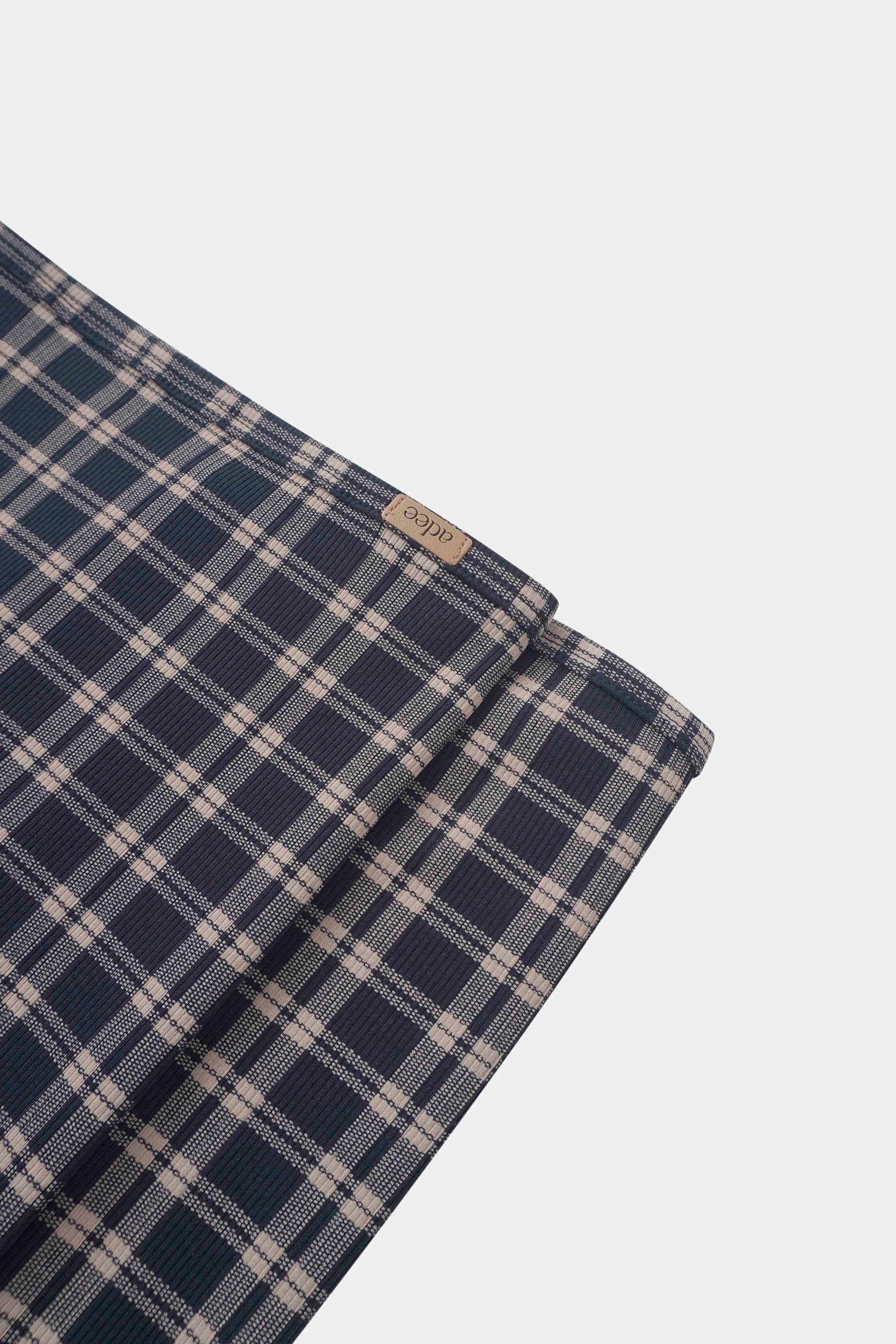 Navy plaid layette set for boys by Adee with beige checks and brand tag.