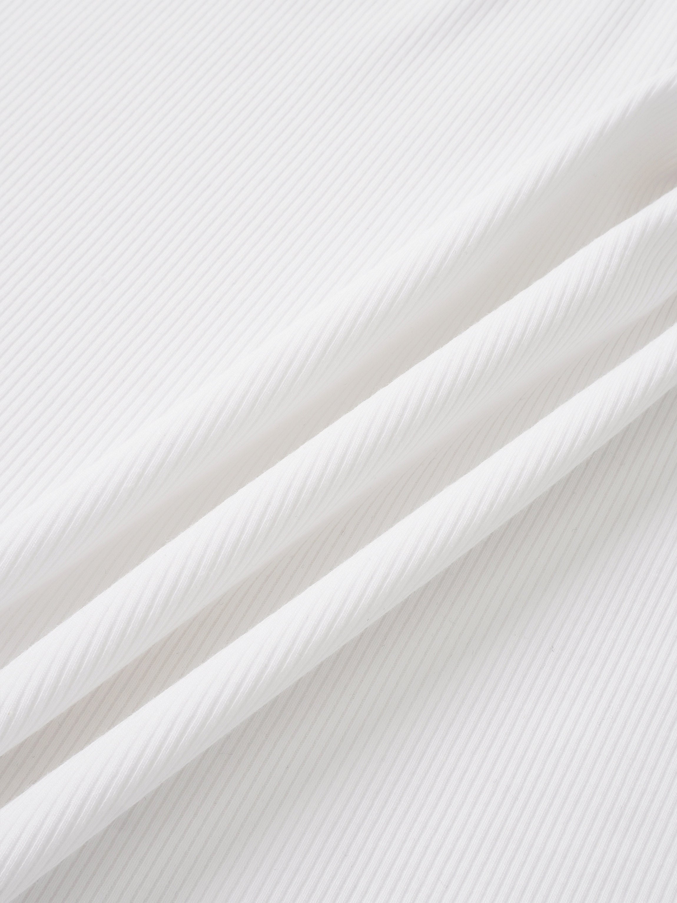Legacy Stitch White layette set fabric close-up; ribbed cotton.
