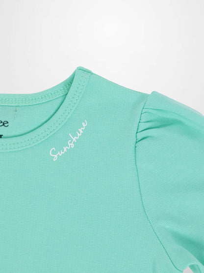 Mint green 3/4 puff sleeve T-shirt with gathered shoulder and white cursive text near neckline.