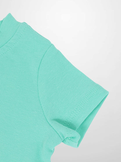Mint green short-sleeve boxy T-shirt close-up showing sleeve seam.