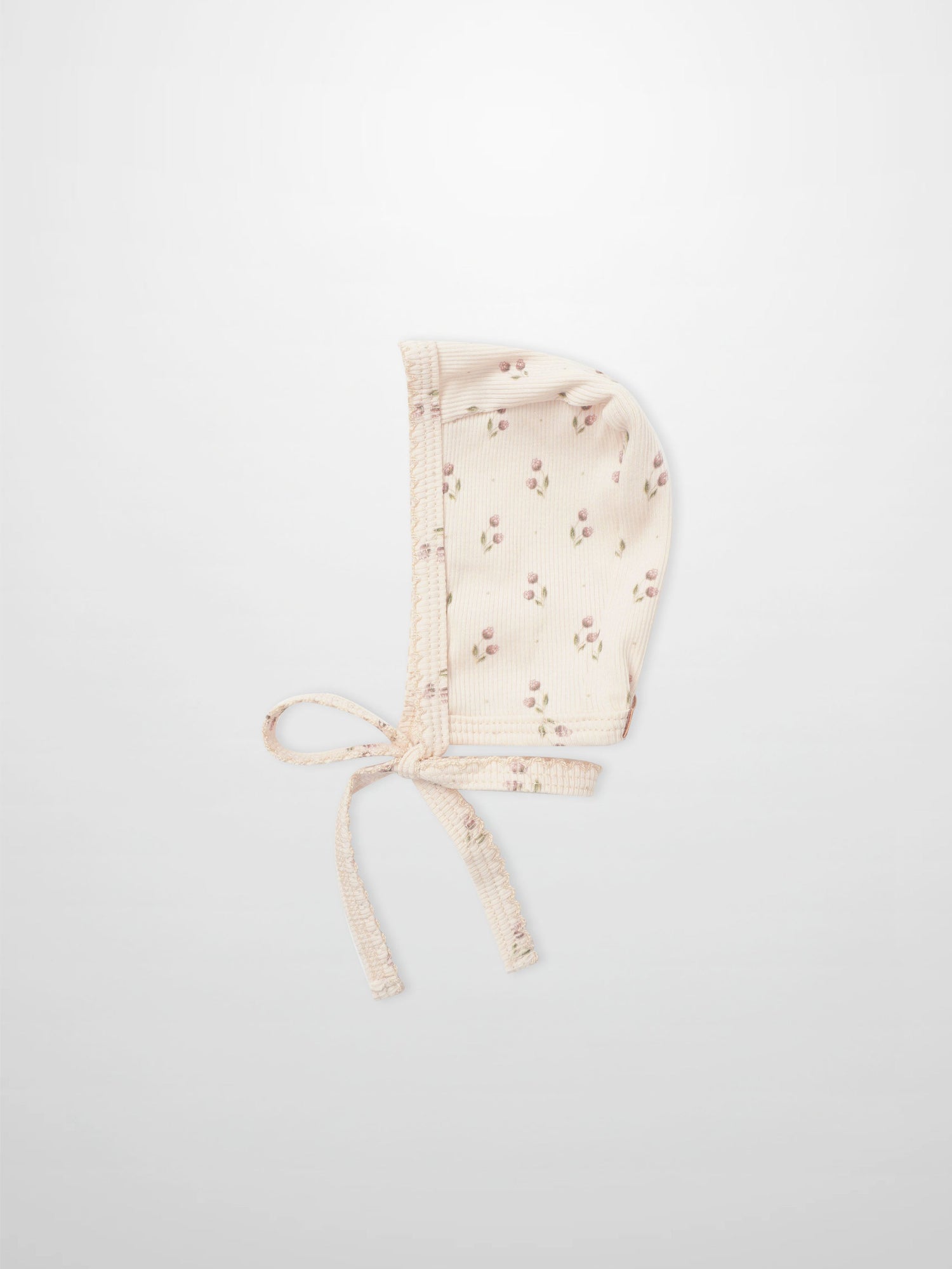 Tiny Tulip layette bonnet in pale pink with tiny floral print and ties