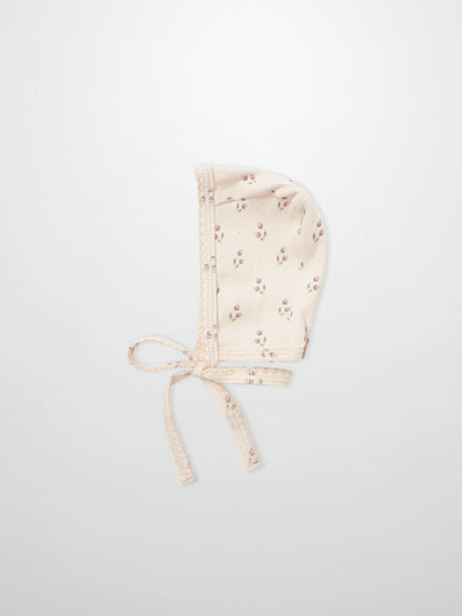 Tiny Tulip layette bonnet in pale pink with tiny floral print and ties