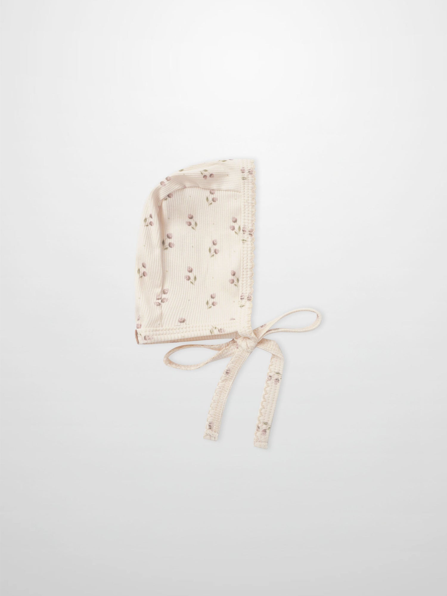Adee Tiny Tulip layette bonnet in cream ribbed fabric with pink floral print and ties