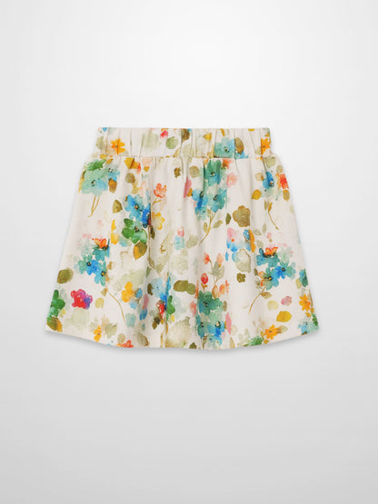 Pastel floral skirt with watercolor blossoms on white, elastic waist, A-line silhouette.