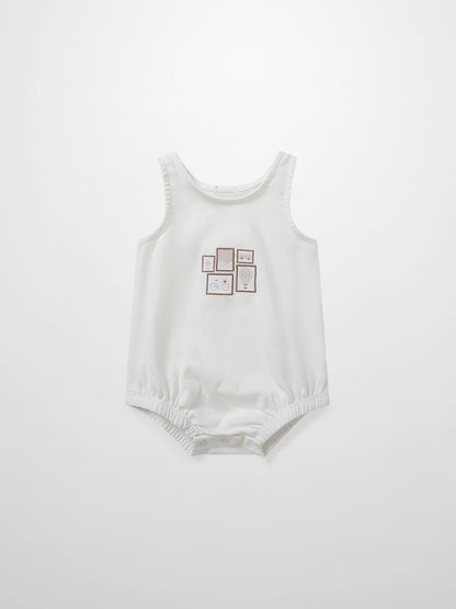 Adee Mini Gallery Romper for baby girls, white sleeveless romper with small framed print on front; snap bottom.