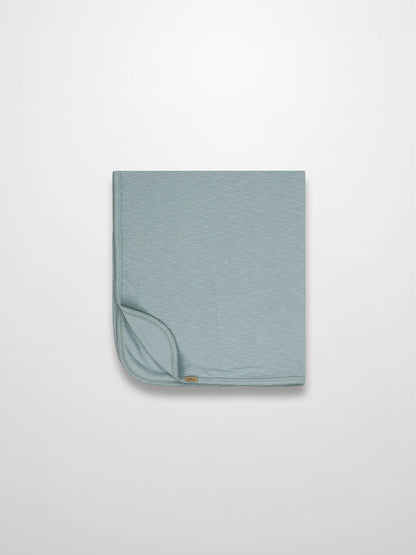 Blue Scalloped Baby Blanket in light blue with subtle texture and delicate scalloped trim, folded corner visible
