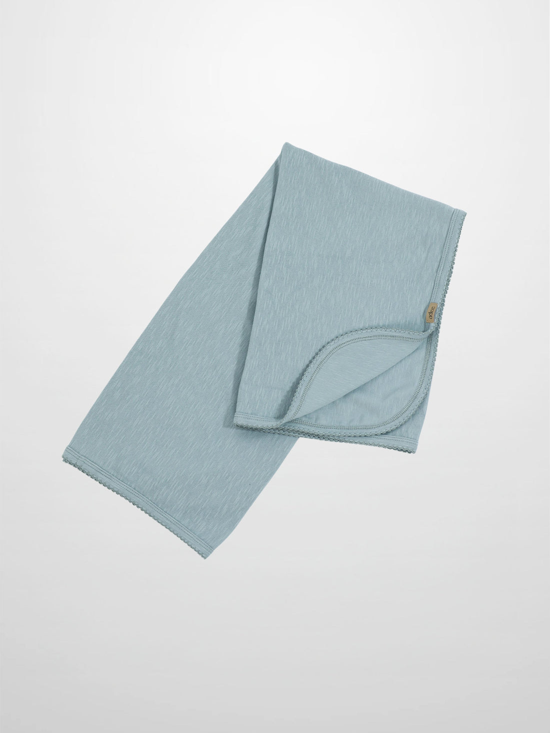 Light blue baby blanket with scalloped trim and soft, textured fabric.
