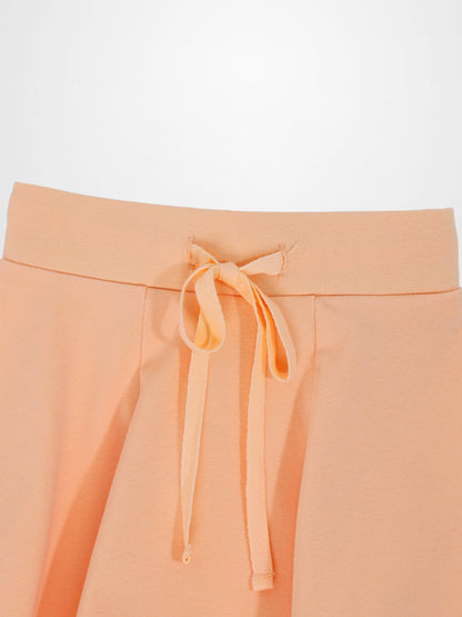 Peach 6-panel skirt with a drawstring waist, close-up of the waistband.