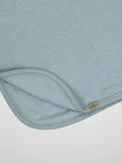Blue scalloped blanket with soft texture and delicate trim for a baby boy.