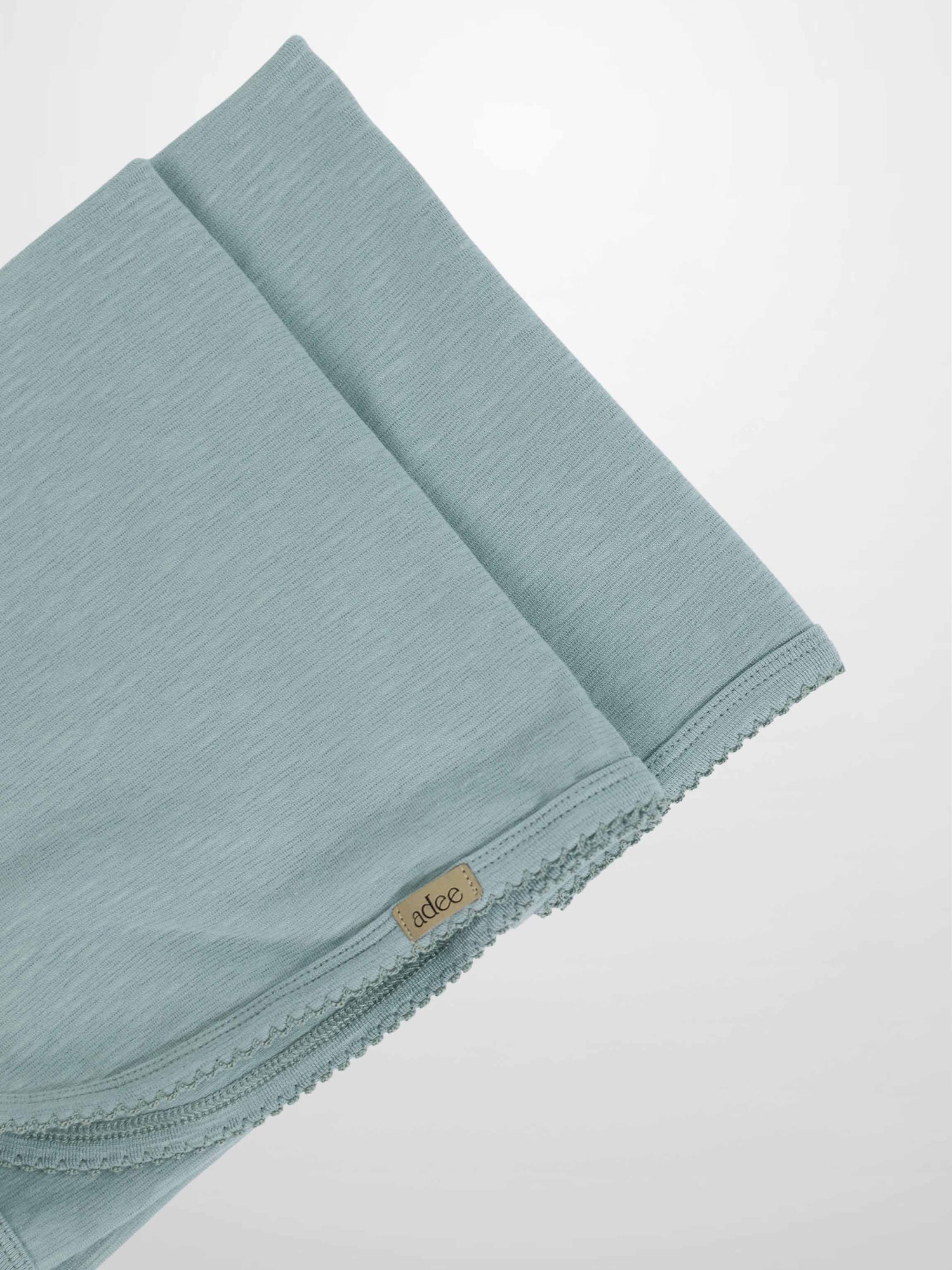 Blue Scalloped Blanket with subtle texture and delicate trim, lightweight and soft for baby’s warm-weather comfort.