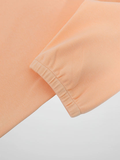 Peach 3/4 puff sleeve T-shirt with elastic cuff close-up.