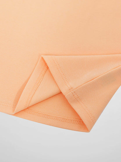 Close-up of peach knit fabric with a folded sleeve hem from a 3/4 sleeve T-shirt.