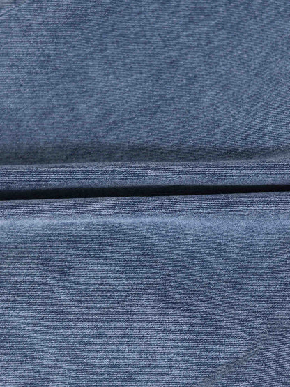 Paneled blue denim skirt fabric close-up.