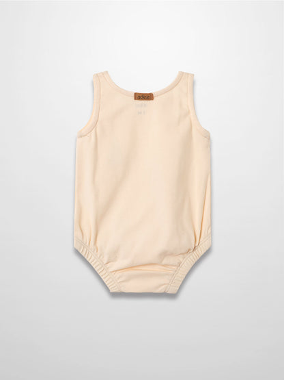 Sail Boat Romper in peach, sleeveless baby romper with elastic leg openings and snaps at bottom.