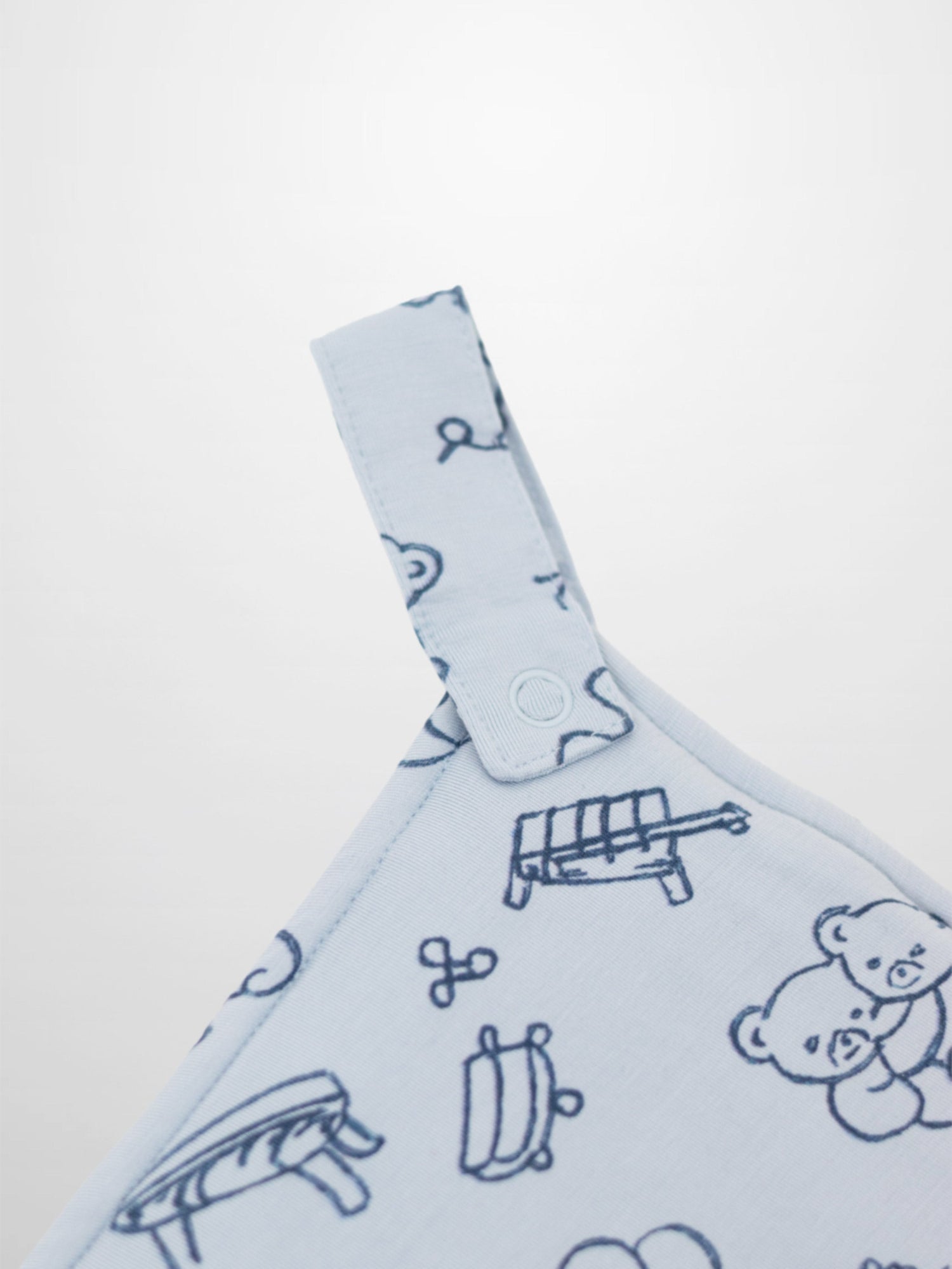 Light blue Storybook Lovey with Clip featuring dark blue carousels, teddy bears, balloons and rocking horses.