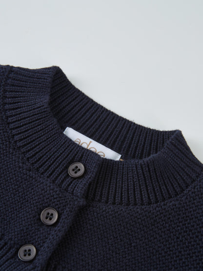Cropped cardigan in navy by Adee, dressy unisex knit with button-front detail.