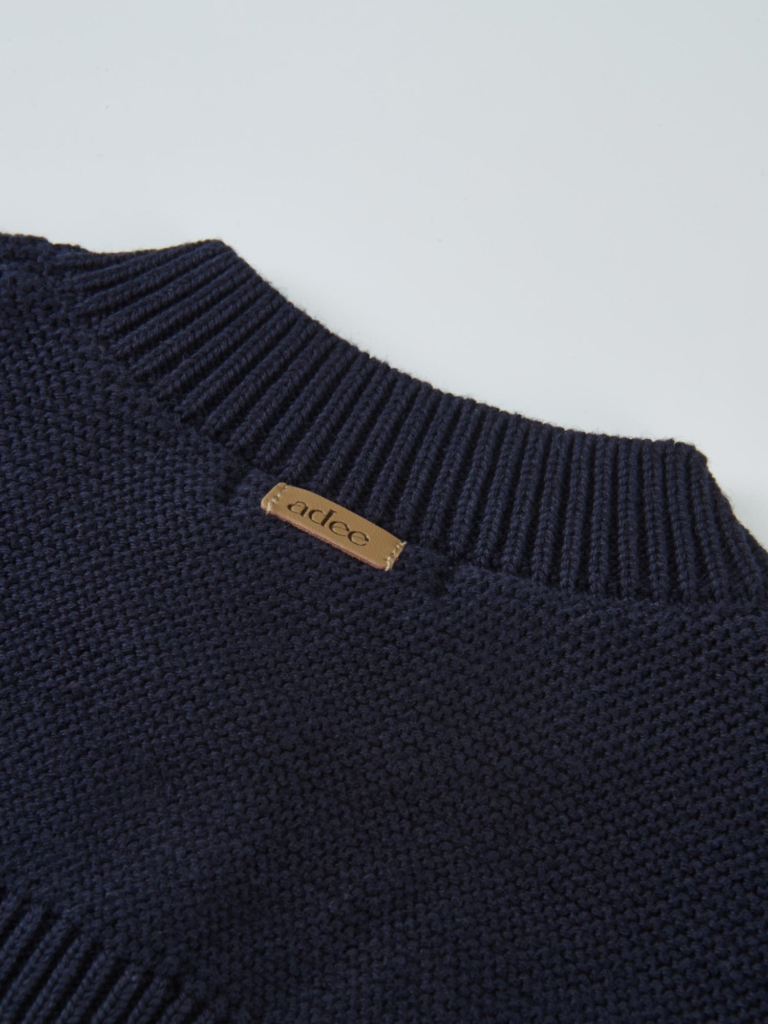 Cropped Cardigan by Adee in navy knit, ribbed neckline with tan leather brand tag
