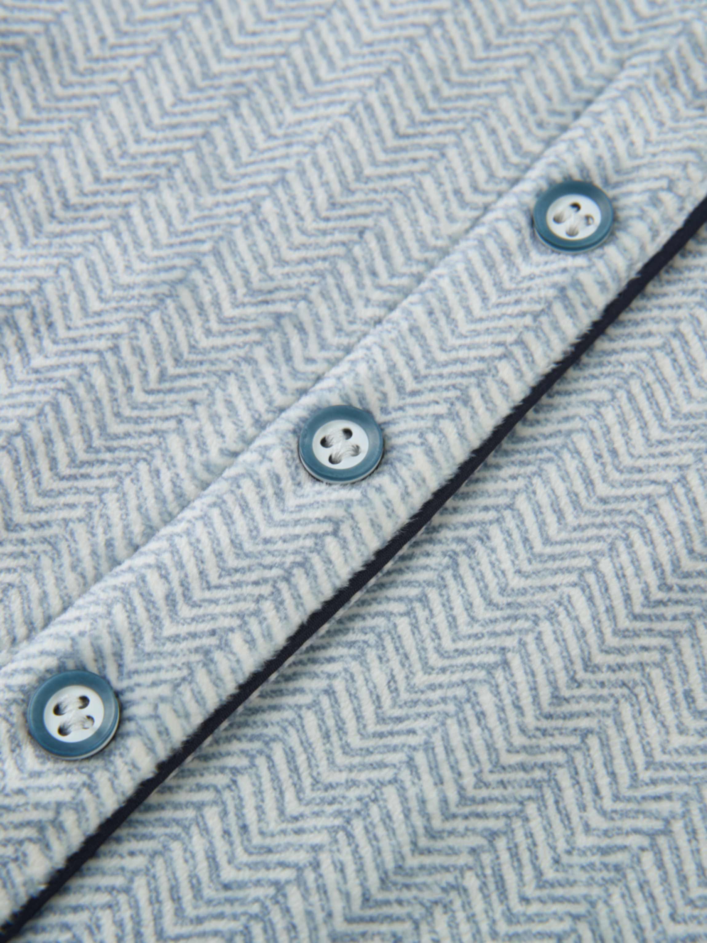 Herringbone Pajamas – Blue for boys by Adee; close-up of blue-gray herringbone fabric with blue buttons and navy trim.