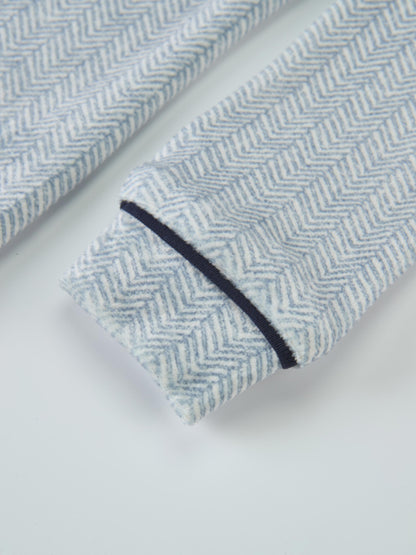 Boys pajamas in blue herringbone fabric with navy piping.