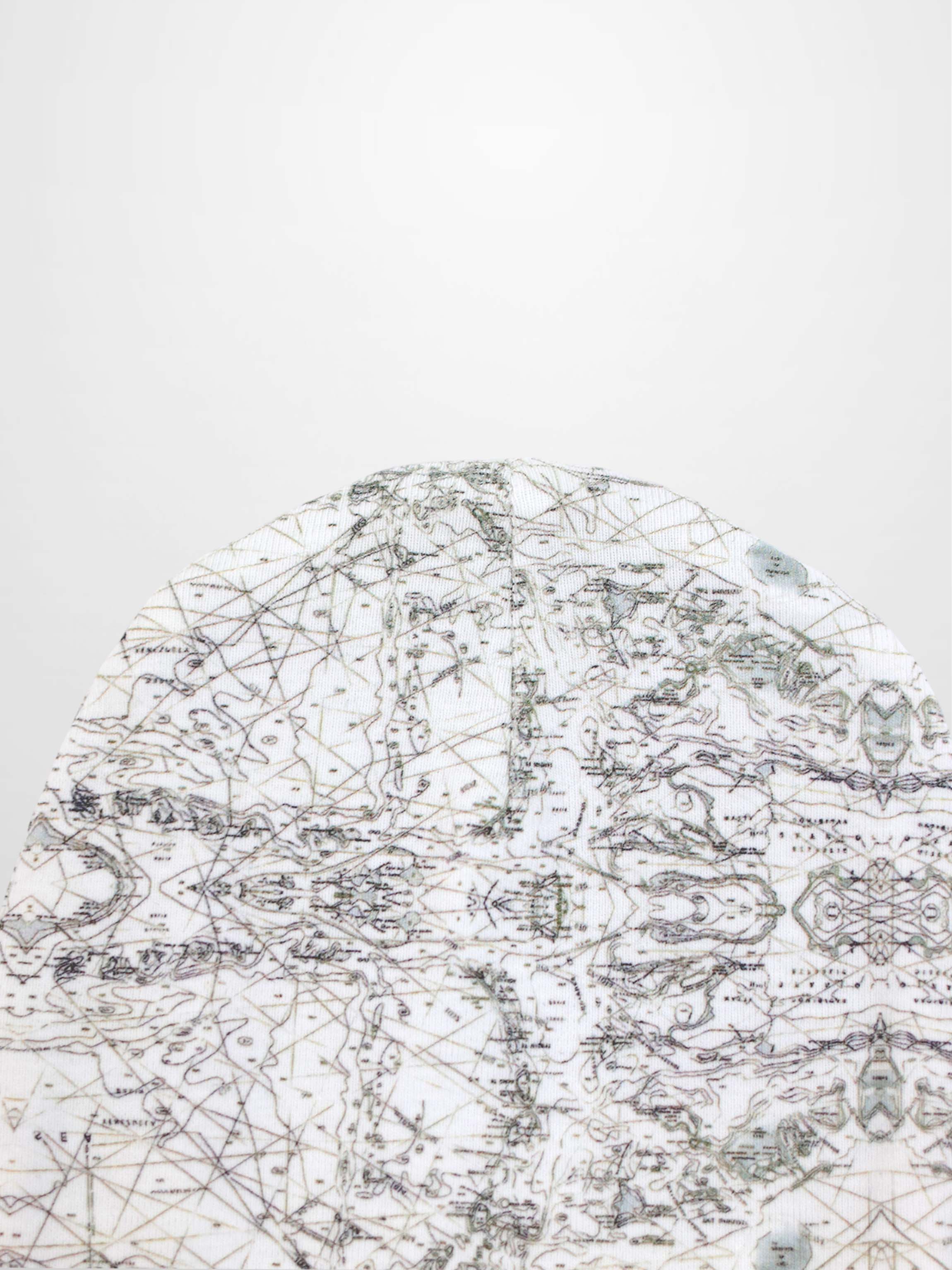 Map Beanie for baby boys in off-white with a fine map print, grey lines, compass marks, and decorative stitching.