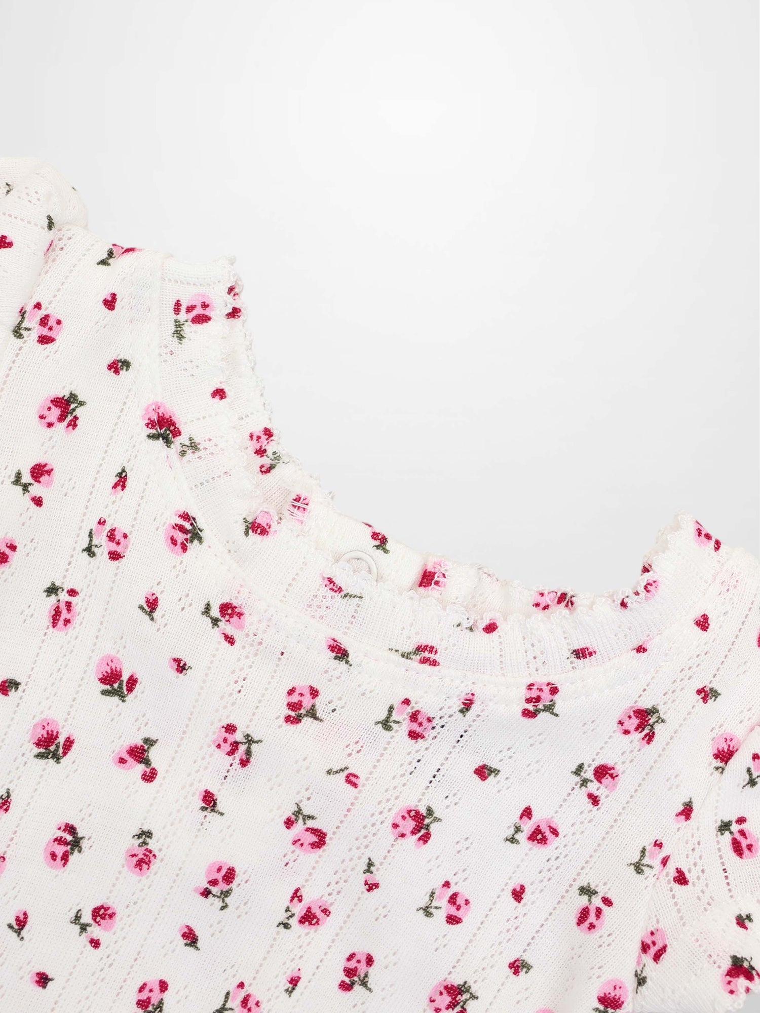 Pointelle Floral Romper for girls by Adee, white knit with pink flowers.