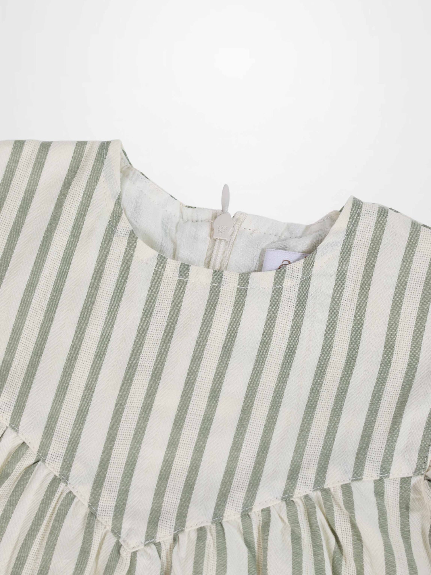 Green and white striped dress neckline featuring a back zipper closure.