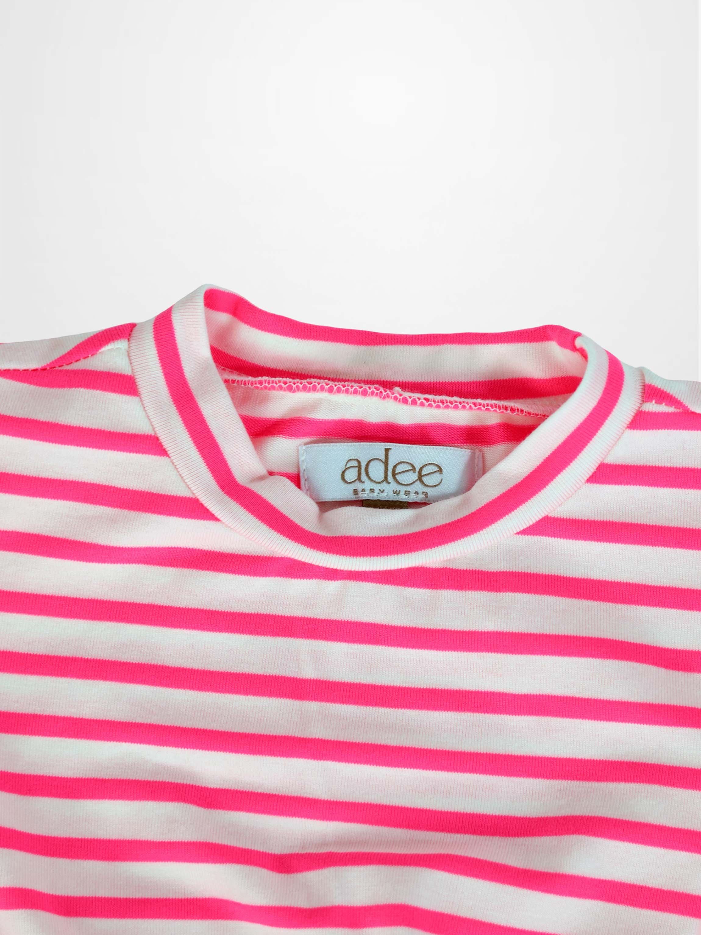 Neon pink and white striped short-sleeve dress neckline close-up with visible brand tag.