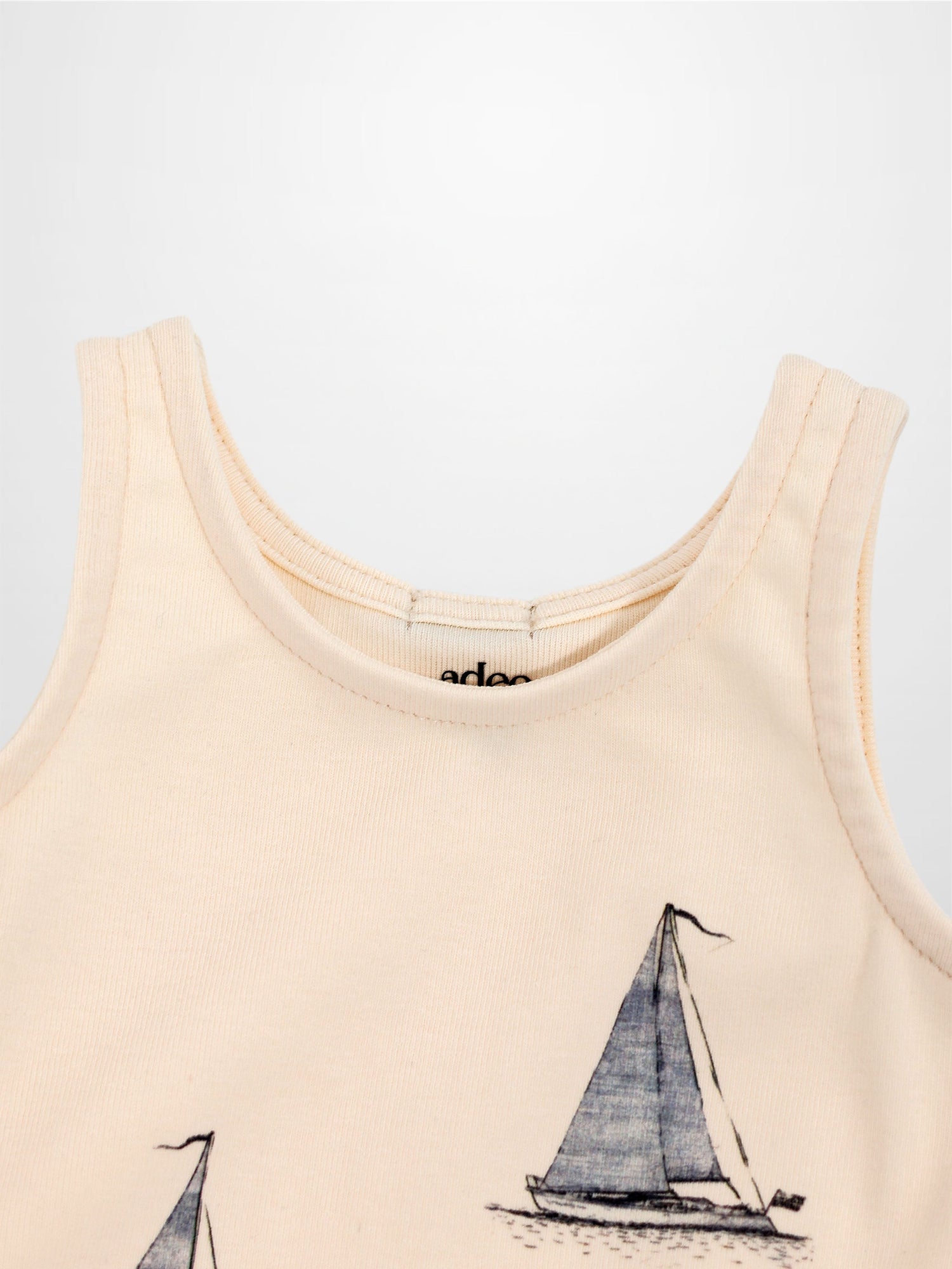 Peach Sail Boat Romper for babies with navy sailboat print, sleeveless.