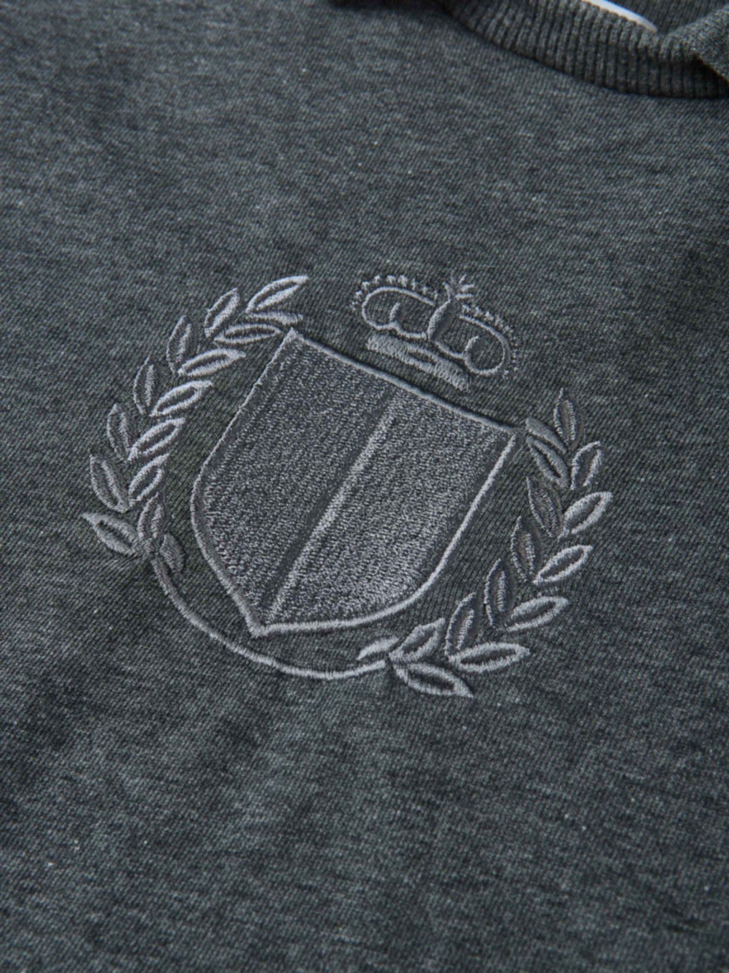 Windsor Sweatshirt by Adee; charcoal gray knit with white embroidered crest and laurel on chest, unisex top.