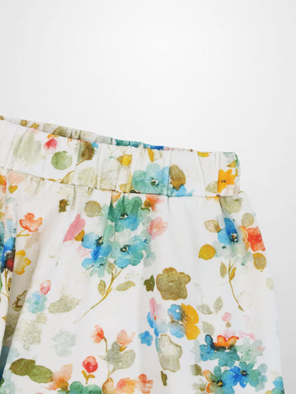 Pastel floral skirt with gathered waistband and colorful blossom print on white fabric