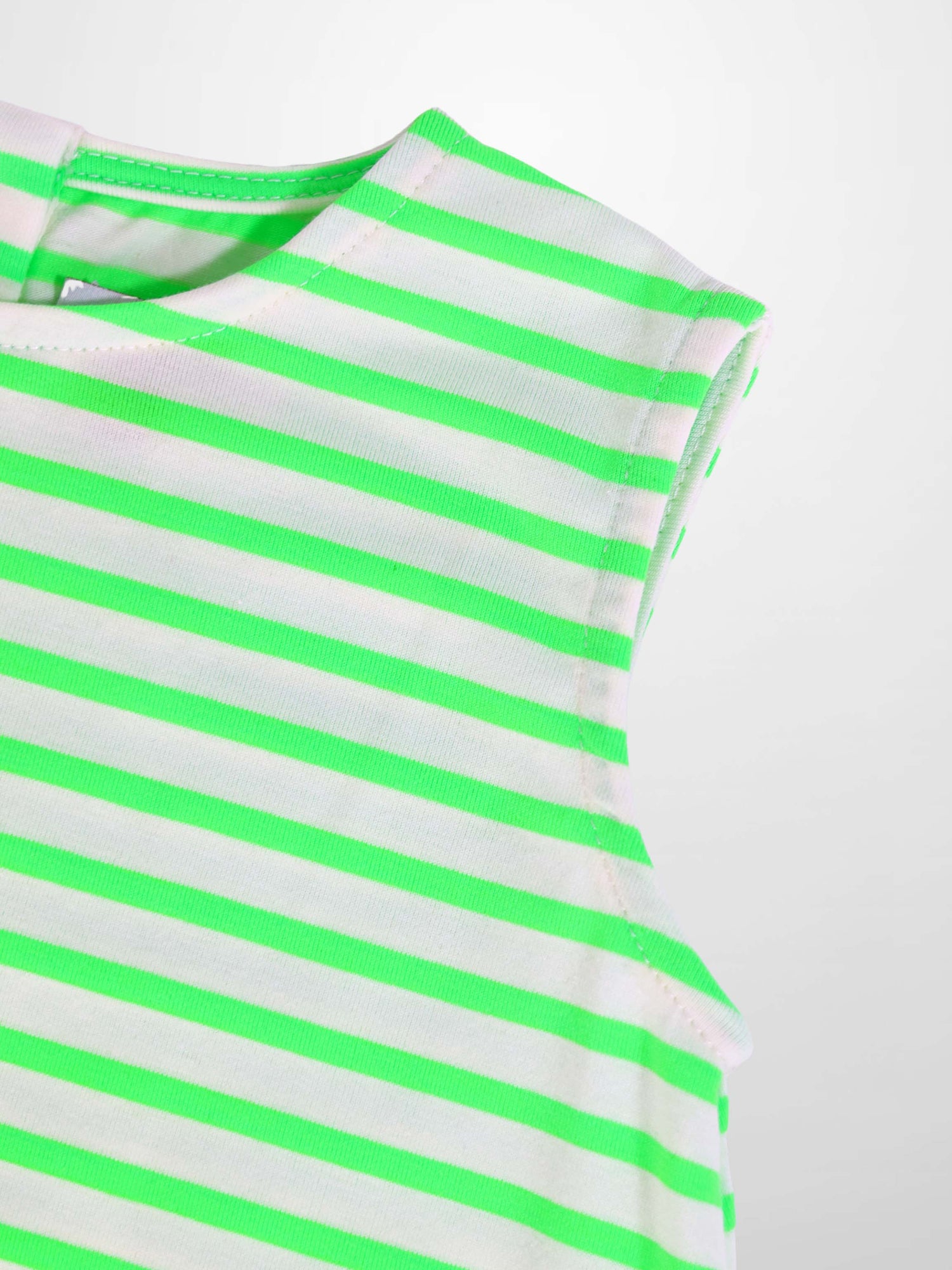 Neon green striped romper fabric close-up at the shoulder.