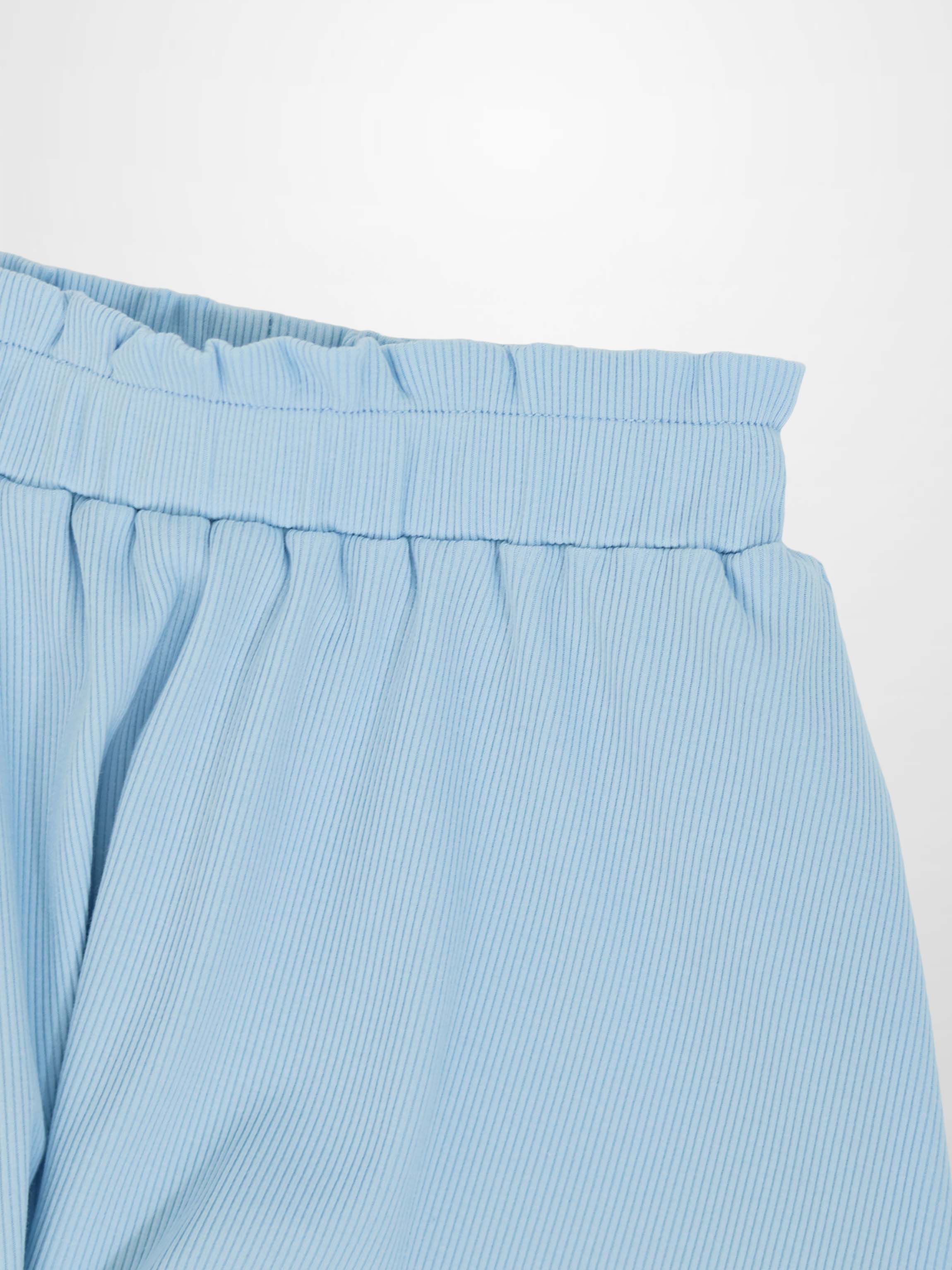 Light blue paper bag waist skirt with elastic waistband and diagonal stripe fabric.