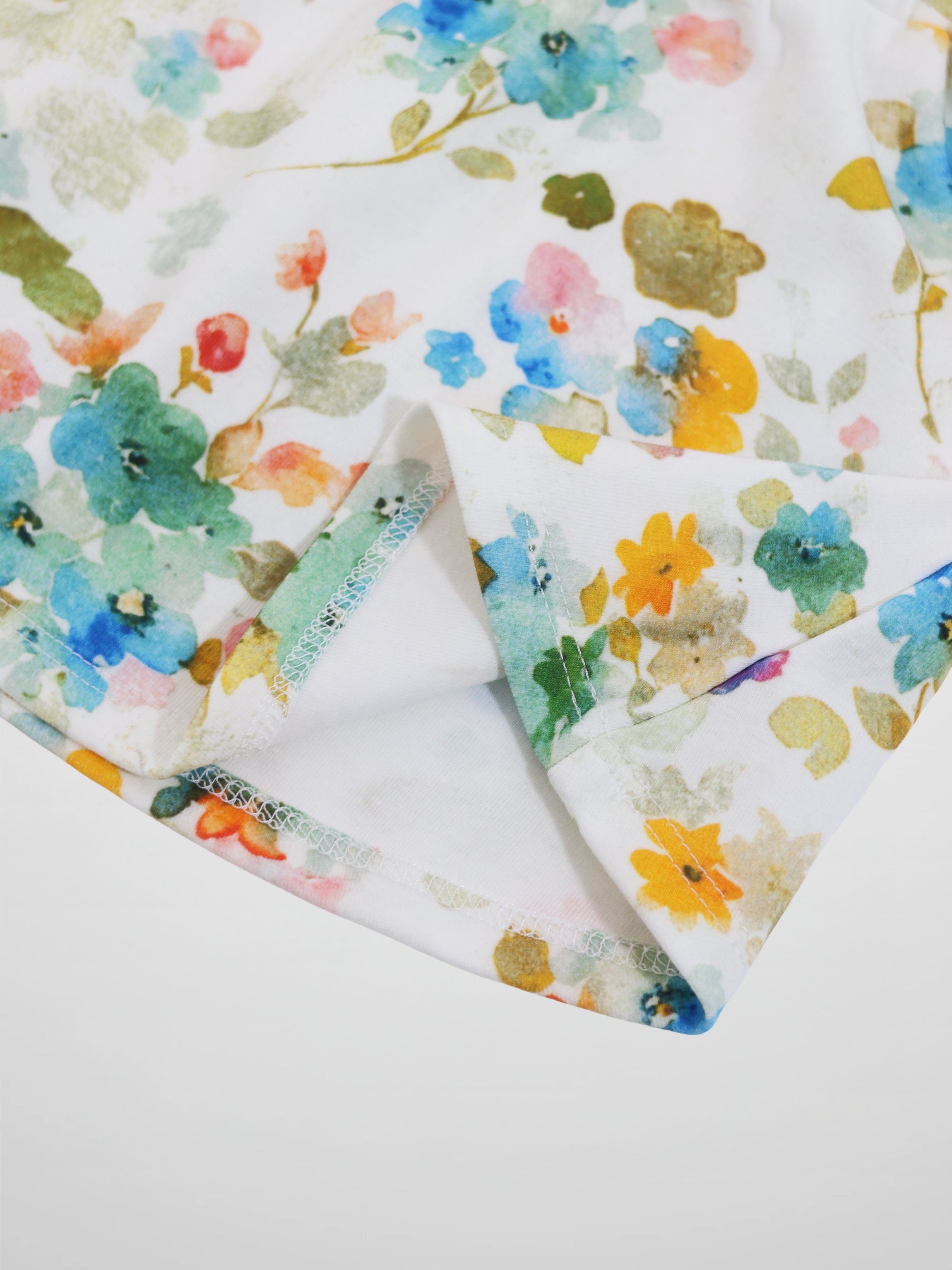 Pastel floral skirt fabric with watercolor flowers on white.