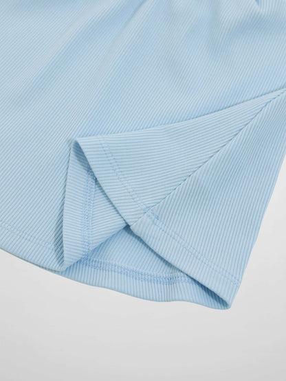 Light blue paper bag waist skirt fabric close-up with folded hem and stitching.