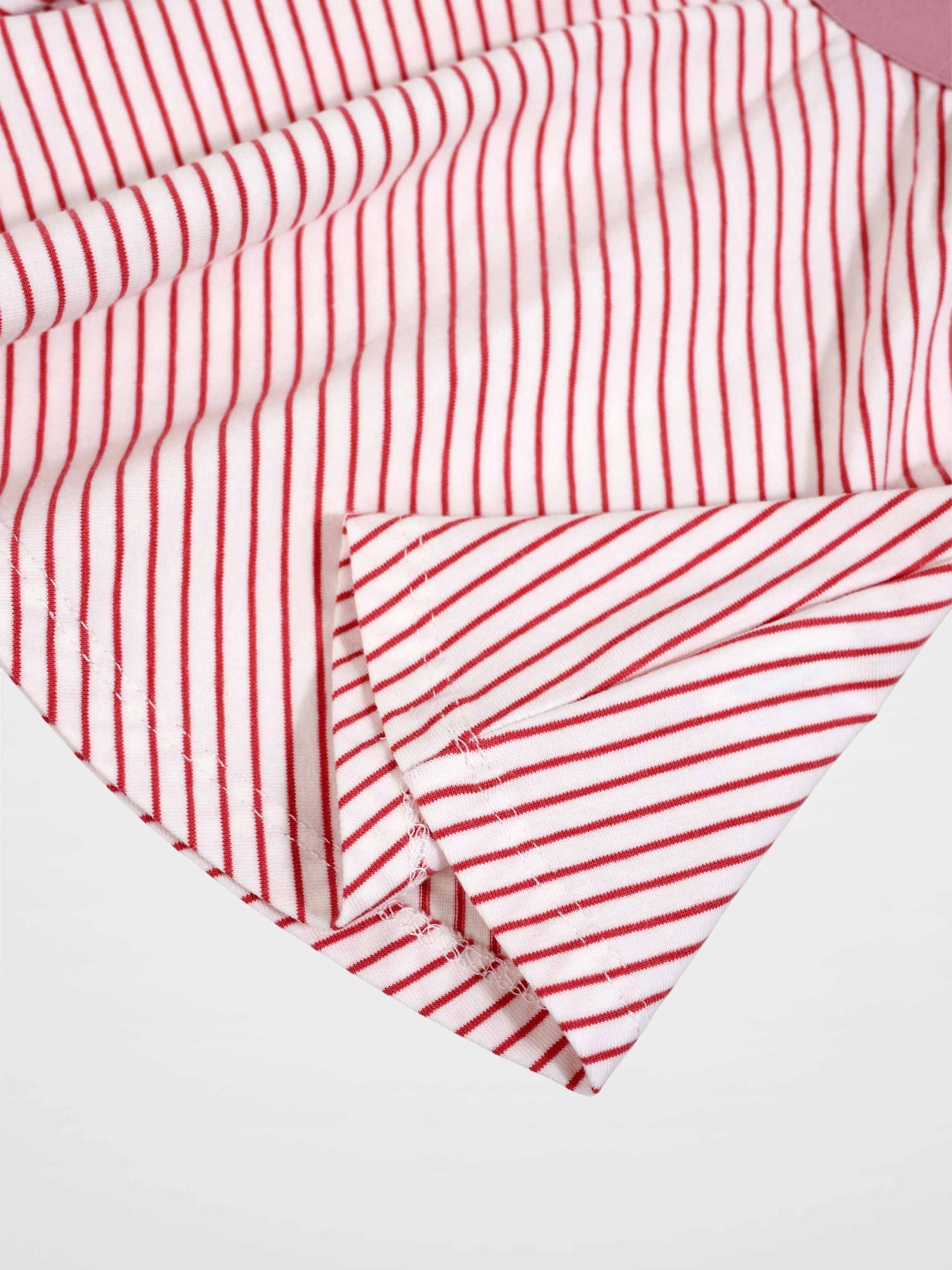 Striped pink girls skirt close-up fabric with red stripes on white background